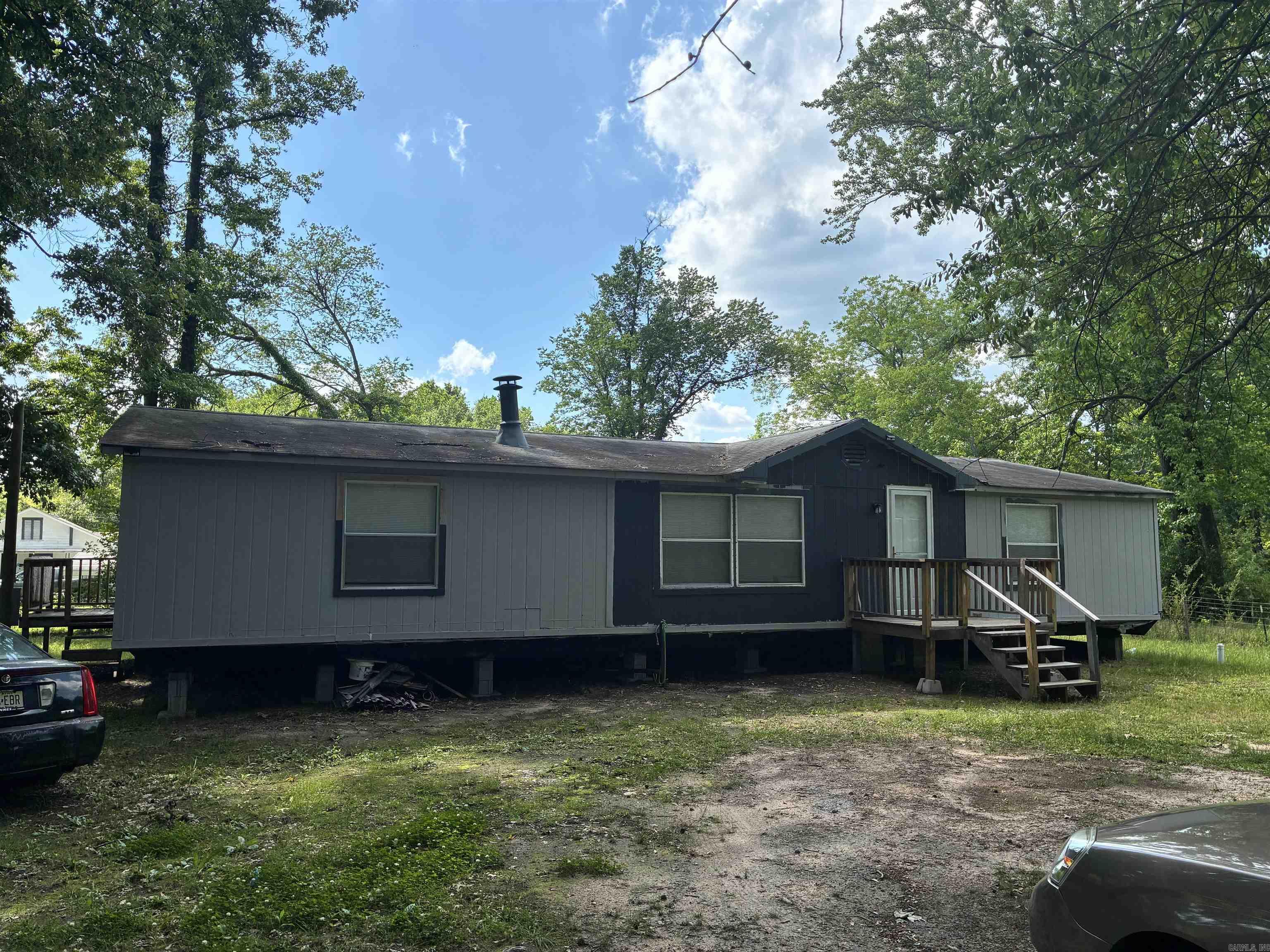 Calling all investors! 406 Happy St offers a value-add opportunity with a 3-bedroom, 2-bath manufactured home featuring approximately 1,568 square feet. Renovations have been started, allowing the next owner to complete the project and build equity. Situated on a corner lot with public water and sewer, this property has solid potential as a rental, or affordable owner-occupant home. Conveniently located in Malvern with easy access to schools, shopping, and major roadways. Sold as-is; bring your tools and imagination. Very little left to do.