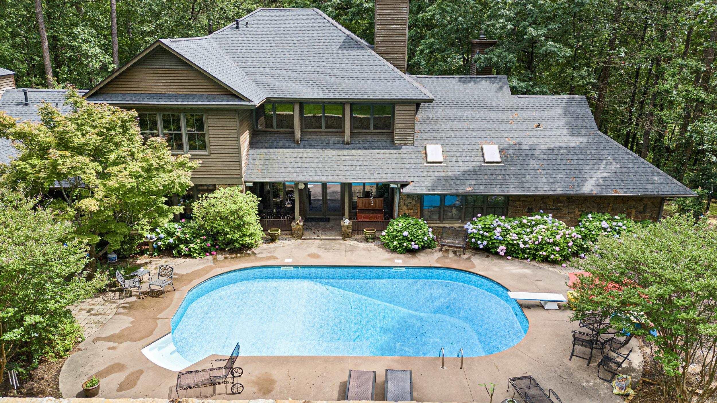 Welcome to your dream home! This stunning 5,310 sq ft home offers a grand layout; 4 spacious bedrooms & 4.5 beautiful bathrooms. The extra-large master suite boasts a cozy fireplace and spa-like bath. At the heart of the home is a gourmet kitchen designed for both everyday living and entertaining, complete with high-end finishes and prep space. The large game room is currently used as a fifth bedroom, offering ultimate flexibility for your lifestyle.  Step outside to your own private paradise—this home sits on a secluded wooded lot with a large outdoor entertaining space; perfect for grilling, cooking, and making memories. Dive into your in-ground pool with a diving board or unwind under the stars in your own serene backyard escape.  Additional highlights include a 2-car garage with ample storage, a detached shop/garage ideal for hobbies, projects, or extra storage. Don’t miss this rare opportunity to own a high-class home that combines elegance, space, and functionality in a tranquil, private setting!