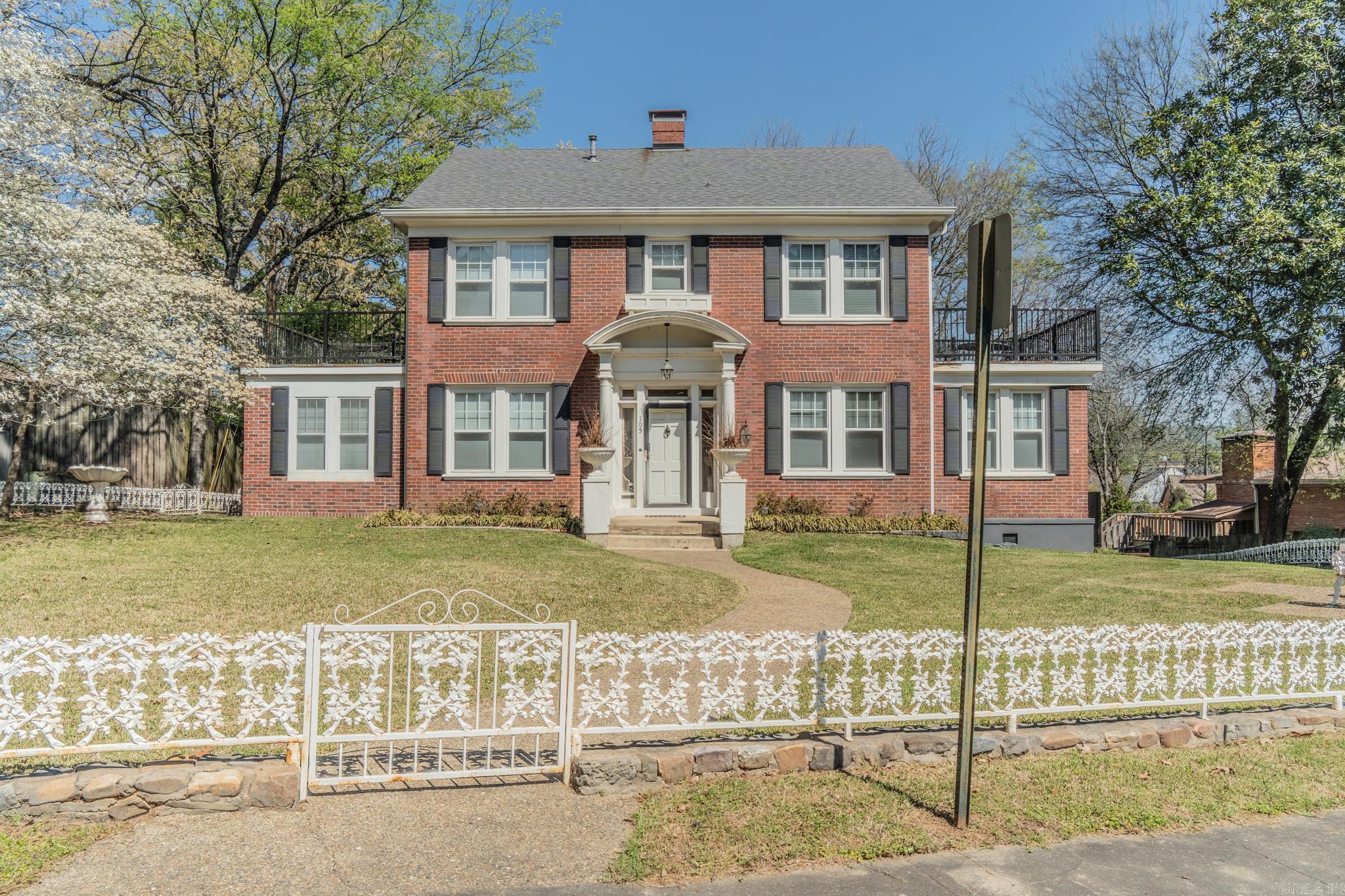 Beautiful Colonial Style home built in 1930. Renovated around 2023. Walk to Oaklawn Racetrack & Casino! This welcoming home has been tastefully updated while leaving many of the original finishes. Walk into the large living room with fireplace, designated office area to one side and a bonus room on the other side that opens up to an outdoor space. Formal Dining room with hardwood floors. Updated kitchen with a moveable Island. Granite countertops and 2 full kitchen sinks. Eat in area and Tile floors. One bedroom on the first floor with a full bath. Close to the living room is a half bath. Upstairs are 3 more bedrooms. The guest bedrooms each have their own outdoor patio and a shared full bathroom. The Primary bedroom is very large with room for a sitting area. The primary closet is more than a walk-in. It has lots of built in's and even a vanity area. There is an attic accessible from the 2nd floor for extra storage or could be finished out. Below the 1st floor is a large basement, lots of possibilities there. In the backyard is a detached 2 car garage and a large area for outdoor entertaining, also fenced. Currently an Airb&b with a transferrable STR license. AGENTS See Remarks