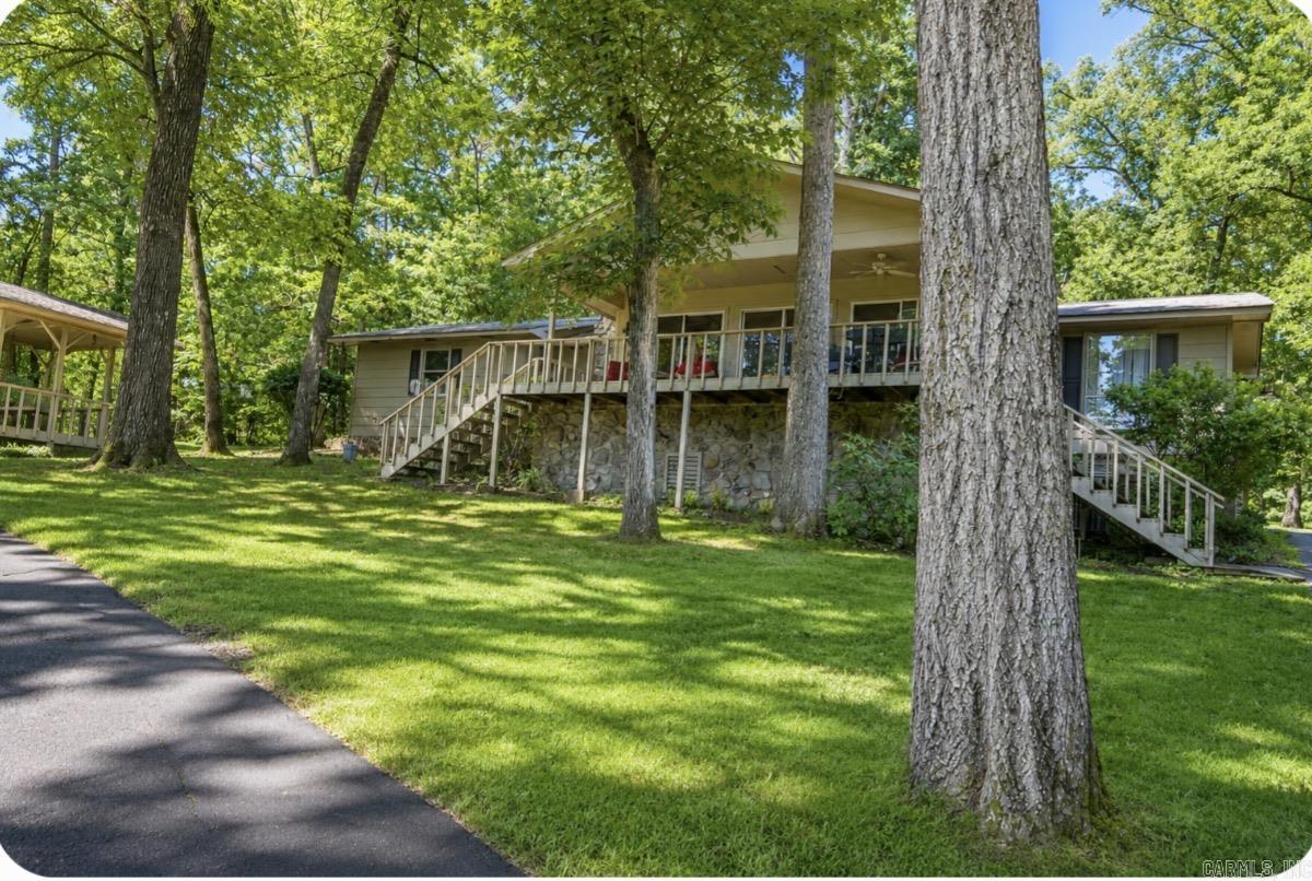 Welcome to 208 Scenic Drive, a rare double-lot property in the Diamondhead subdivision, offering beautiful lake views and unbeatable proximity to Lake Catherine State Park. With one POA due across both lots, this oversized homesite provides exceptional value and flexibility. The home sits in the LSSD school district and offers the perfect foundation for a future short-term rental or vacation retreat. With a little thoughtful updating, this property could easily become a true hidden gem—a peaceful getaway surrounded by nature, recreation, and the charm of the Diamondhead Community, Amenities include a 18- Hole golf course, Olympic size swimming pool,Tennis/Pickelball courts, club house and playground. Whether you’re looking to invest, create a weekend escape, or enjoy everyday living with lake views, This home delivers space, potential, and location all in one.