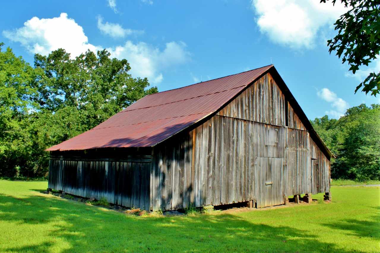 This 81.5-acre property is a rare find. At the gated entrance, the property opens up into a beautiful 10-acre pasture with an almost 100-year-old hay barn, newer metal shop with electric, and pavilion, equipped with septic, electric, and water hookups. There are lots of trails through the woods. A year-round creek cuts through the center of the property, and there are huge white oaks on the banks. Food plots sprinkled throughout. Tons of deer, turkey, and even a few quail cubbies. Minerals do not convey.