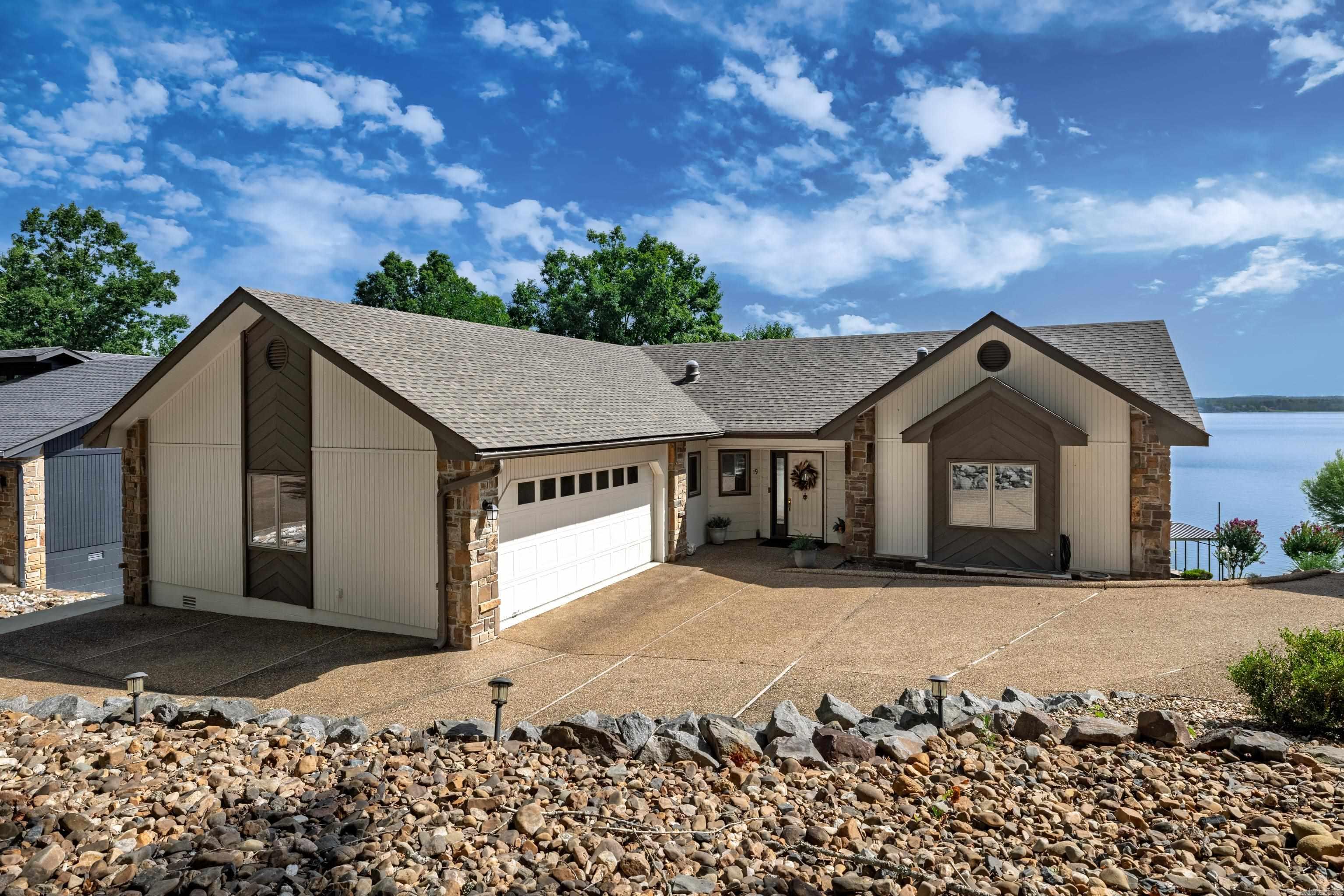 Rare opportunity on Lake Balboa! This custom-built waterfront home has been beautifully updated and features a desirable split floor plan with 4 bedrooms, a den, and a spacious bonus room that could easily serve as a 5th bedroom, office, or game room. Fresh paint, new flooring, and updated fixtures make this home move-in ready. Enjoy breathtaking panoramic views from the expansive BONUS 200 sq. ft. sunroom with a wall of windows overlooking the water (not included in the home's  square footage). The primary suite offers a stunning full-tile walk-in shower and peaceful lake views. Step outside to multiple entertaining spaces, including extended decks leading to the lakeside deck, private dock, and boat lift. The lower level features a private exterior entrance with access to the den, bedroom, full bath, and bonus room, ideal for guests or multi-generational living. An oversized deep garage and abundant storage provide plenty of room for all your lake toys. Combining quality construction, thoughtful updates, and one of Lake Balboa's most sought-after waterfront locations, this exceptional property is ready to be your next lakefront retreat.