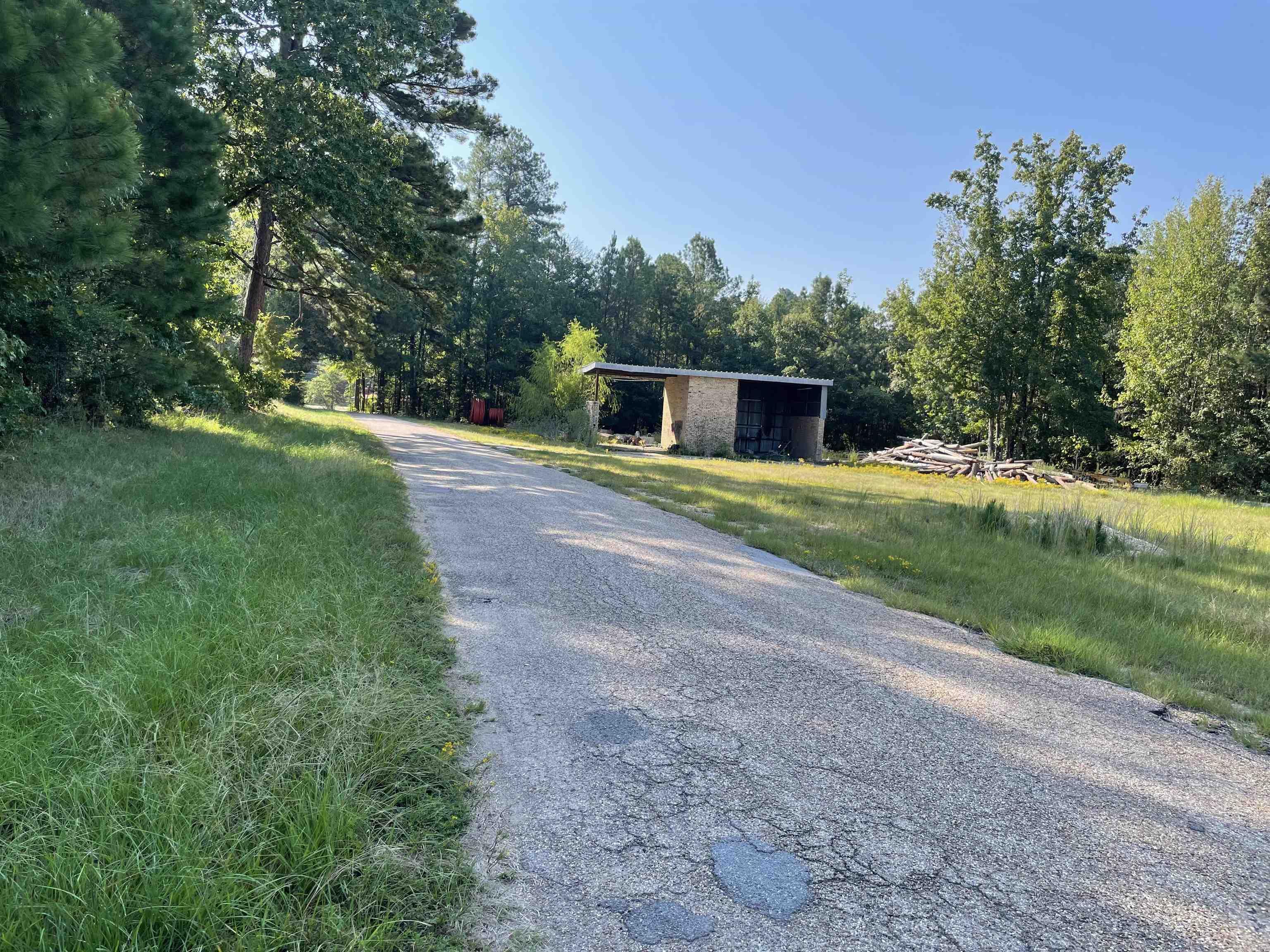 A great place for a small business.  Property is a corner lot, paved road with highway frontage. There was once a two-bay car wash on this property but it is just being used for storage currently.  The acreage does have utilities on it.