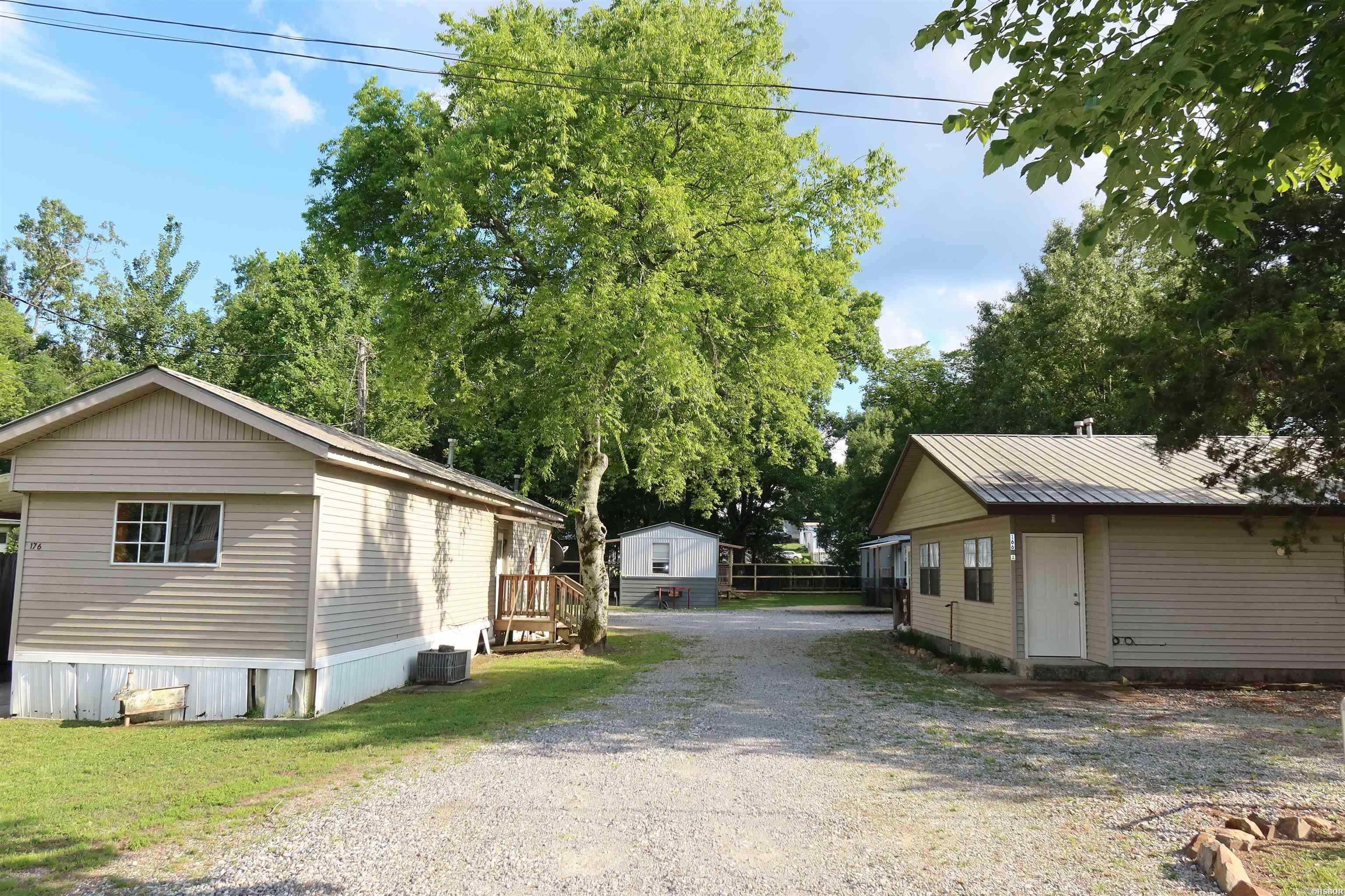 This is a fantastic opportunity to purchase your first multi-family property or expand your investment portfolio with a strong income-producing package. The property includes 1 duplex, 3 mobile homes and a large shop with covered areas that offer additional storage and/or rental income potential. With estimated potential rental income of approximately $5,600 per month, this property presents excellent cash flow opportunities. Four of the five units have been renovated, adding value and increasing tenant appeal. The property is partially fenced and features a mix of 1- and 2-bedroom units in a convenient location within walking distance to Dollar General and Harps Grocery. Situated in the highly sought-after Lakeside School District, this property is an outstanding investment opportunity with established income, added amenities, and room for continued growth.
