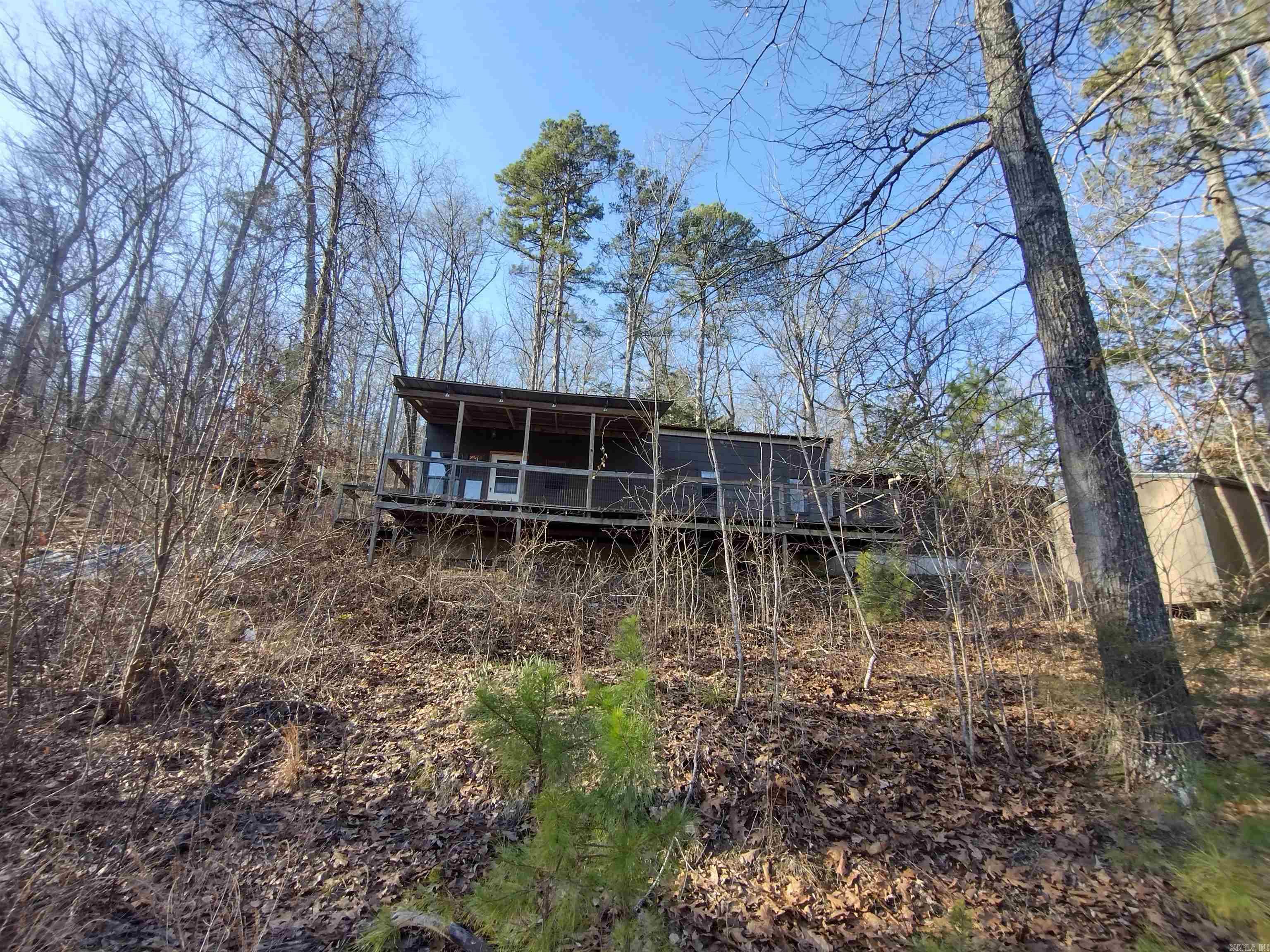 This would make a great little getaway cabin has great views of Hanford bluff and sits just minutes to Round bottom boat landing has two nice storage sheds does need one bedroom finished being sold as-is