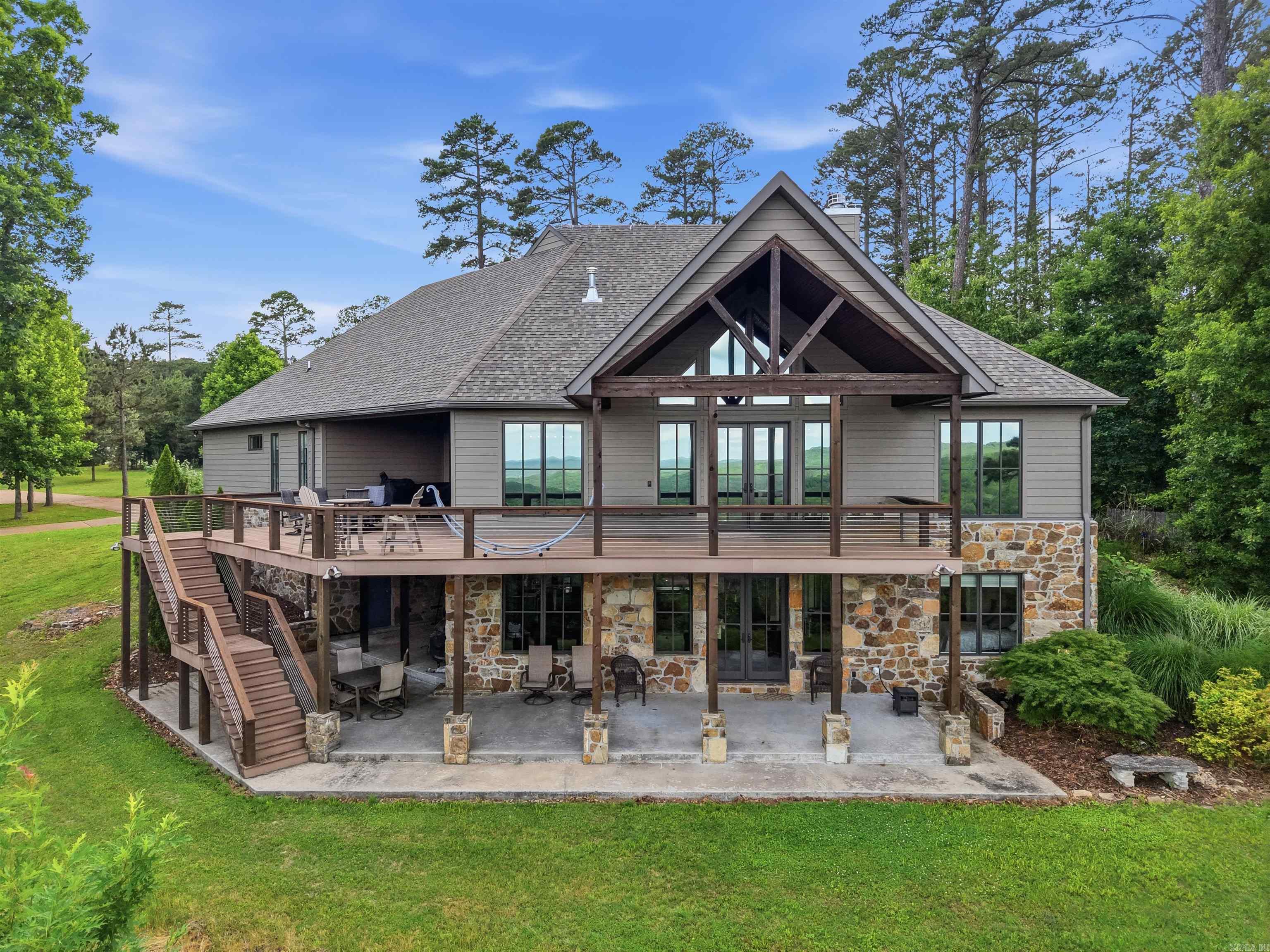 Sitting on the bluff of Greers Ferry lake sits an impeccable built home with a breathtaking view of the lake along with a marvelous view of the countryside. This home is everything you could have thought of & more. Open floorplan allowing the stunning great room(vaulted ceiling/gas log fireplace/built-in shelving & cabinets) to flow with the kitchen & dining.  All with the view of the lake. Kitchen hosts a double pantry, pull-out cabinets, breakfast bar & multiple hardsurfaced working areas for the Chef in the family & helpers.  The master BR with wood vaulted ceiling leads to a spectacular master bath with whirlpool soak tub, huge walk-in shower with double rain shower heads & walk-in closet. The upper laundry area is spacious with wash sink & folding area. Full kitchen down stairs with a large den & its own laundry room for lower level. Perfectly laid-out home for guest, in-laws & out-laws that may be living with you. Detached 24x30 Shop.