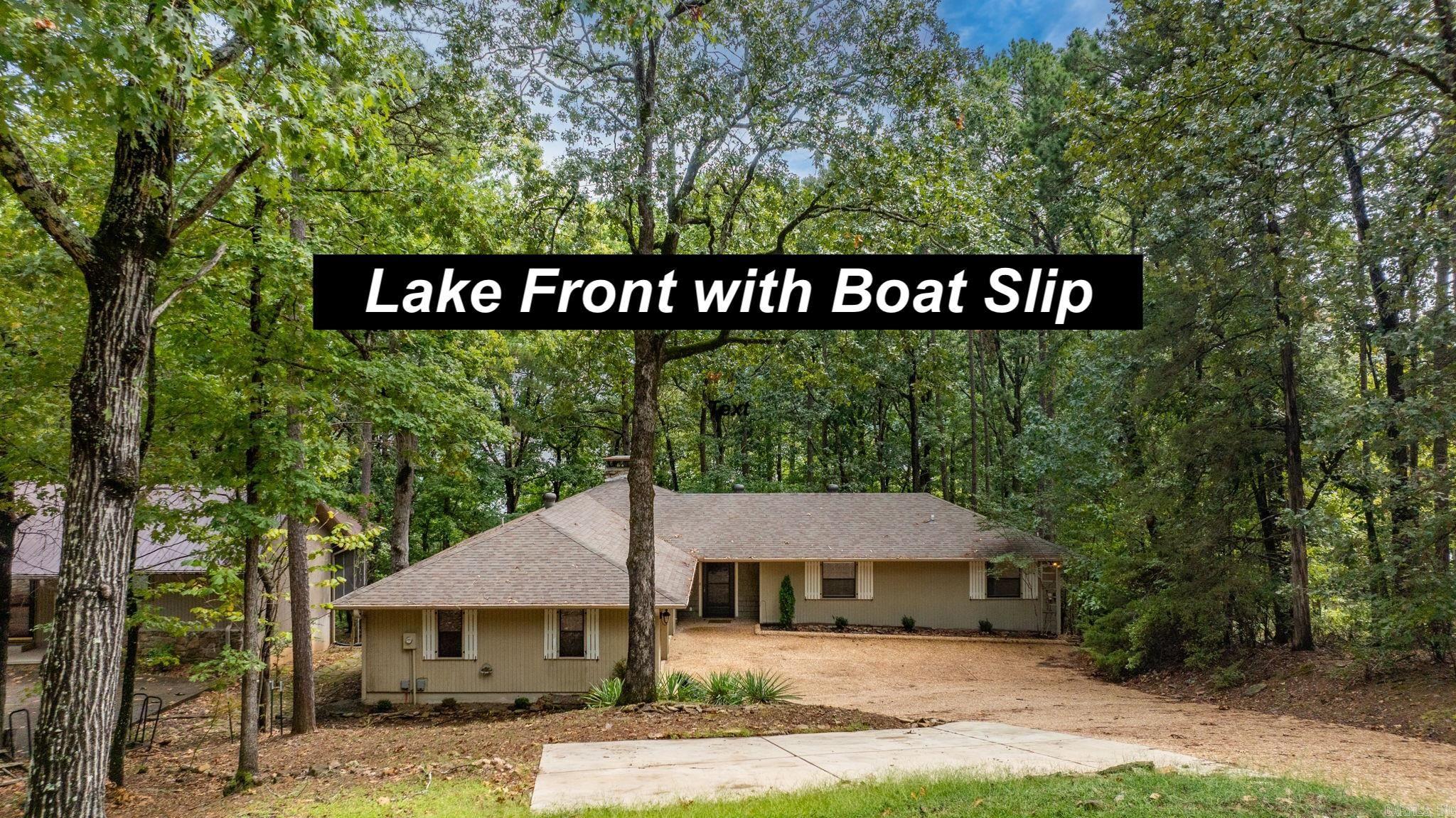 LAKEFRONT LIVING AT ITS FINEST! This beautifully remodeled 3-bedroom, 2-bath home offers the perfect blend of comfort, style, and functionality—all with stunning lakefront access and your very own private boat dock. Step inside to soaring vaulted ceilings and a cozy wood-burning fireplace, creating a warm and inviting living space. The kitchen comes equipped with a new refrigerator and microwave, while the home itself boasts a new heating and air system for peace of mind. The oversized garage and extra parking pad provide ample space for vehicles, toys, and guests. Outdoor living is just as impressive with a fire pit in the backyard, under-house storage, and a 6-foot-wide Army Corps–approved path leading directly to the water. The aluminum boat dock is equipped with a storage cabinet and a solar-powered boat lift, making lake days effortless. Additional updates include a 2-year-old water heater and roof ensuring this home is truly move-in ready. Whether you’re looking for a full-time residence or the perfect weekend retreat, this property delivers the ultimate lake lifestyle.