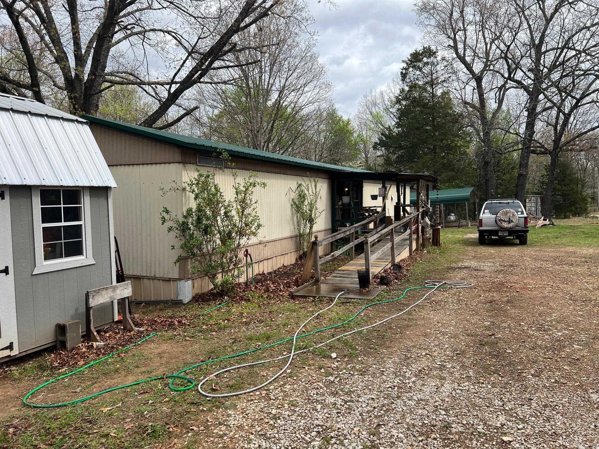 Five acres close to the Buffalo National River.  On a paved road a few miles from Gilbert Ar know as the coolest town in Arkansas and the only incorporated town within the National River Boundary. 1984 3 bedroom 1 bath mobile home.  Updated with New Metal Roof, New Mini Split, New water Heaters, very energy efficient. Comes with an additional fifth wheel camper on its own electrical meter and under metal carport for additional living space or rental space. Two storage buildings and a 40 foot con x container convey at closing. Home has a water filtration system and backup propane heat. All appliances convey, lawn equipment convey, and furniture is negotiable.
