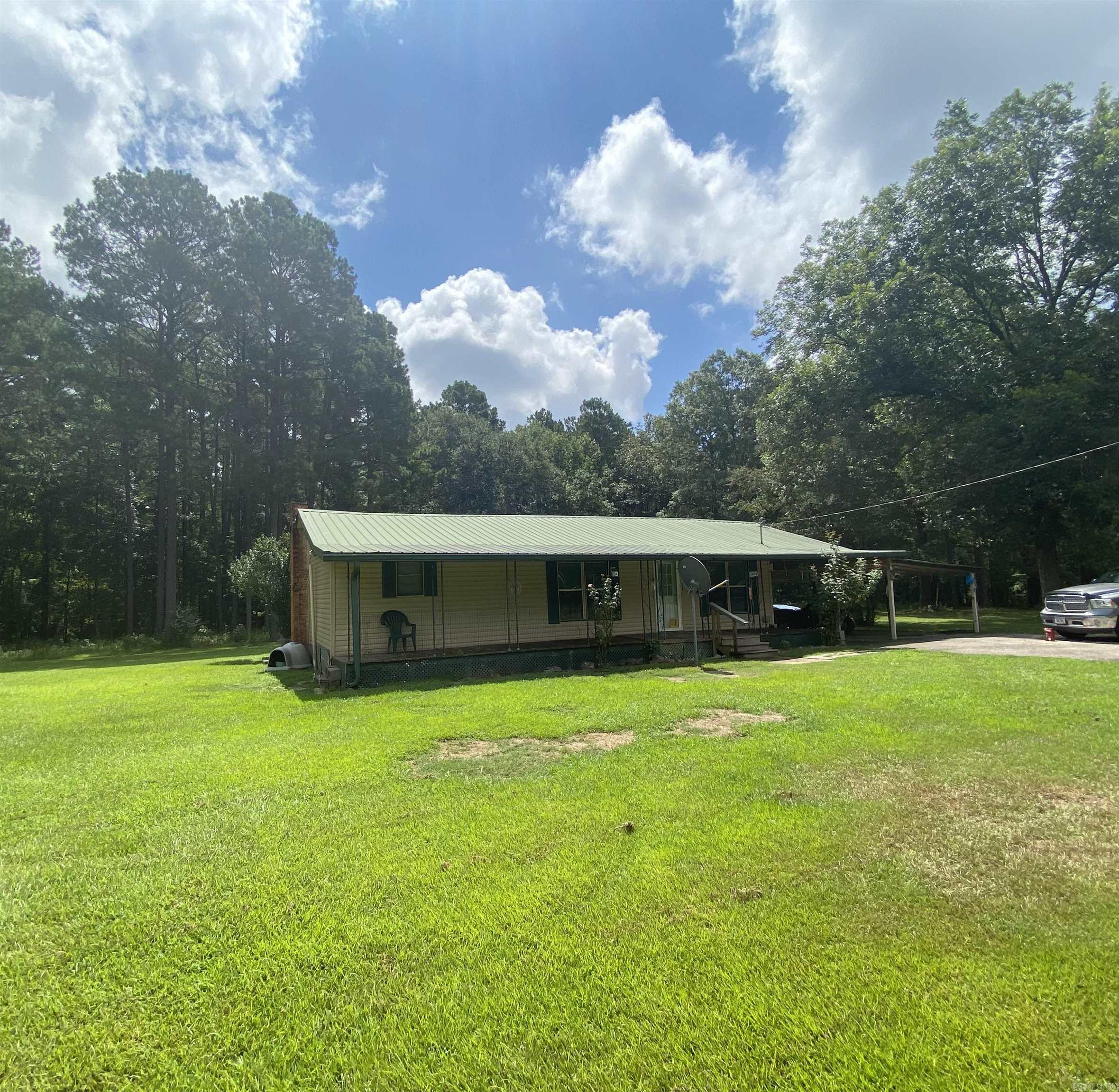 This charming 3-bedroom, 1-bath farmhouse sits on 10.28 picturesque acres, offering a peaceful country setting surrounded by mature trees that provide shade and natural beauty. The home features a durable metal roof, a cozy, comfortable layout perfect for everyday living. Multiple storage buildings on the property offer ample space for equipment, hobbies, or extra storage. Whether you’re looking for room to roam, garden, or simple enjoy the quiet of rural life, this property offers the perfect blend of charm, space, and functionality. This property is sold “as is, where is”, seller will not make repairs. No property disclosure will be provided. Buyer is responsible for having utilities turned on for inspections on the property. Square footage, lot size, and acreage is taken from courthouse records.