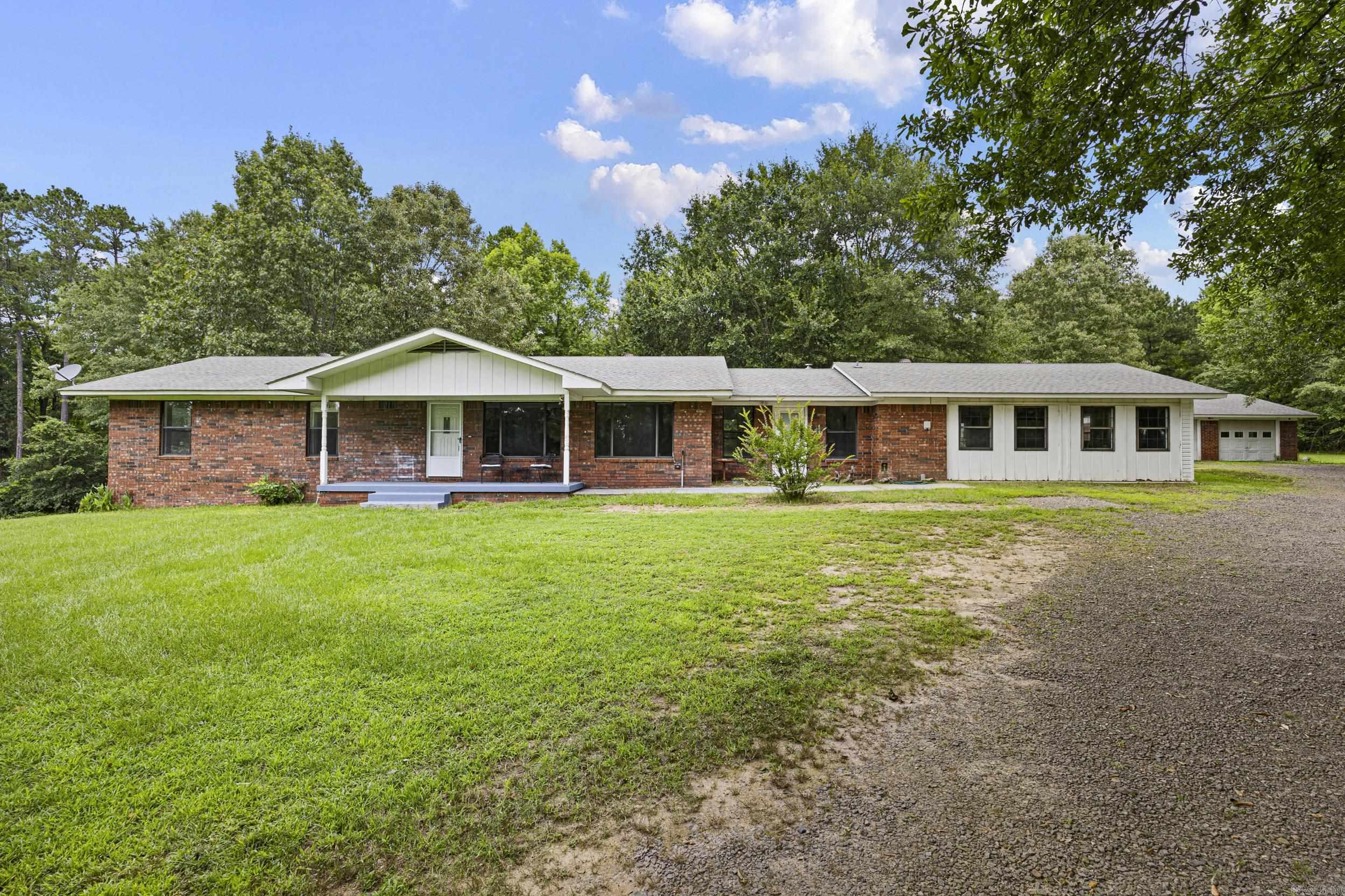 Welcome to this well-maintained, one-owner, single-story home on 3.84 level acres just outside Dover. Offering approximately 2,200 square feet, this 3-bedroom, 3-bath home features a spacious, versatile floor plan with two bonus living areas perfect for a den, media room, game room, or home office. The former attached two-car garage has been converted into additional living space, making it ideal for a mother-in-law suite, guest quarters, home business, or recreation room, and can easily be converted back to an attached garage if desired. The property also includes a detached two-car garage, sunroom, and multiple outbuildings, including a pole barn for RV storage, hobbies, or projects. Enjoy peaceful country living with plenty of space, just minutes from Dover and a short drive to Russellville.