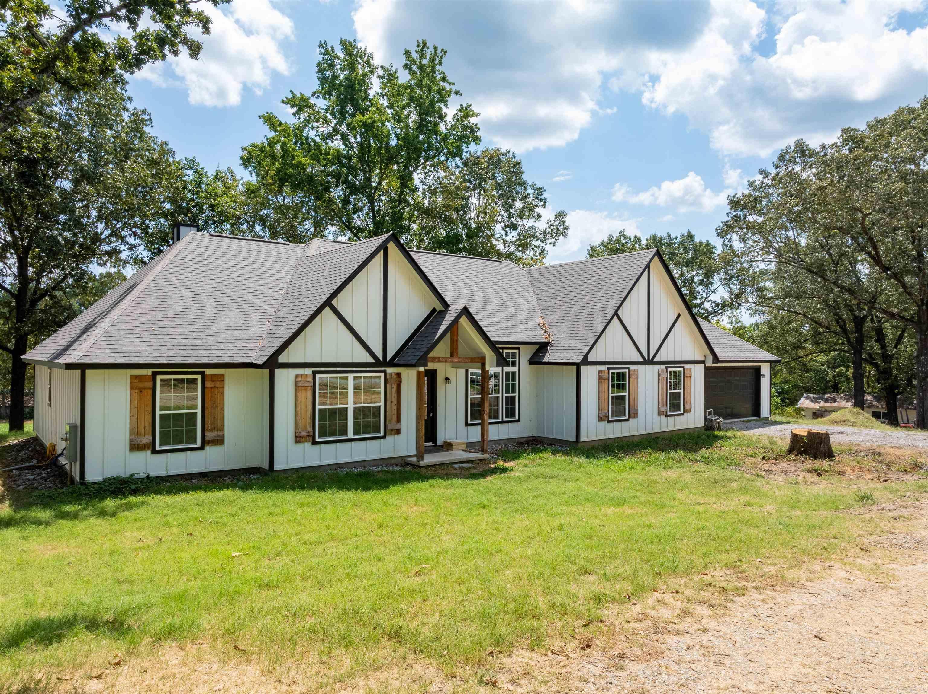 Why wait to build when you can move into a custom home today? This thoughtfully designed 5-bedroom, 3-bath home on approximately 2 peaceful acres offers the perfect blend of modern luxury and country living just minutes from Batesville. Step inside to an open-concept floor plan featuring a spacious living area with an electric fireplace, a formal dining room, and a chef-inspired kitchen designed to impress. Complete with granite countertops, custom dark shaker cabinetry, a commercial-style stainless gas range with dual ovens and multiple burners, an oversized vent hood, pot filler, designer tile backsplash, abundant workspace, and a pantry, this kitchen is built for everything from weeknight dinners to holiday entertaining. The private primary suite is a relaxing retreat with a soaking tub, tiled walk-in shower, and oversized walk-in closet. A bonus pantry/storage room, two-car garage, and covered back porch overlooking the rolling hills complete this exceptional property. If you've been searching for a move-in-ready home with quality craftsmanship, thoughtful design, and room to grow, this is one you truly need to experience in person. Photos simply don't do it justice.