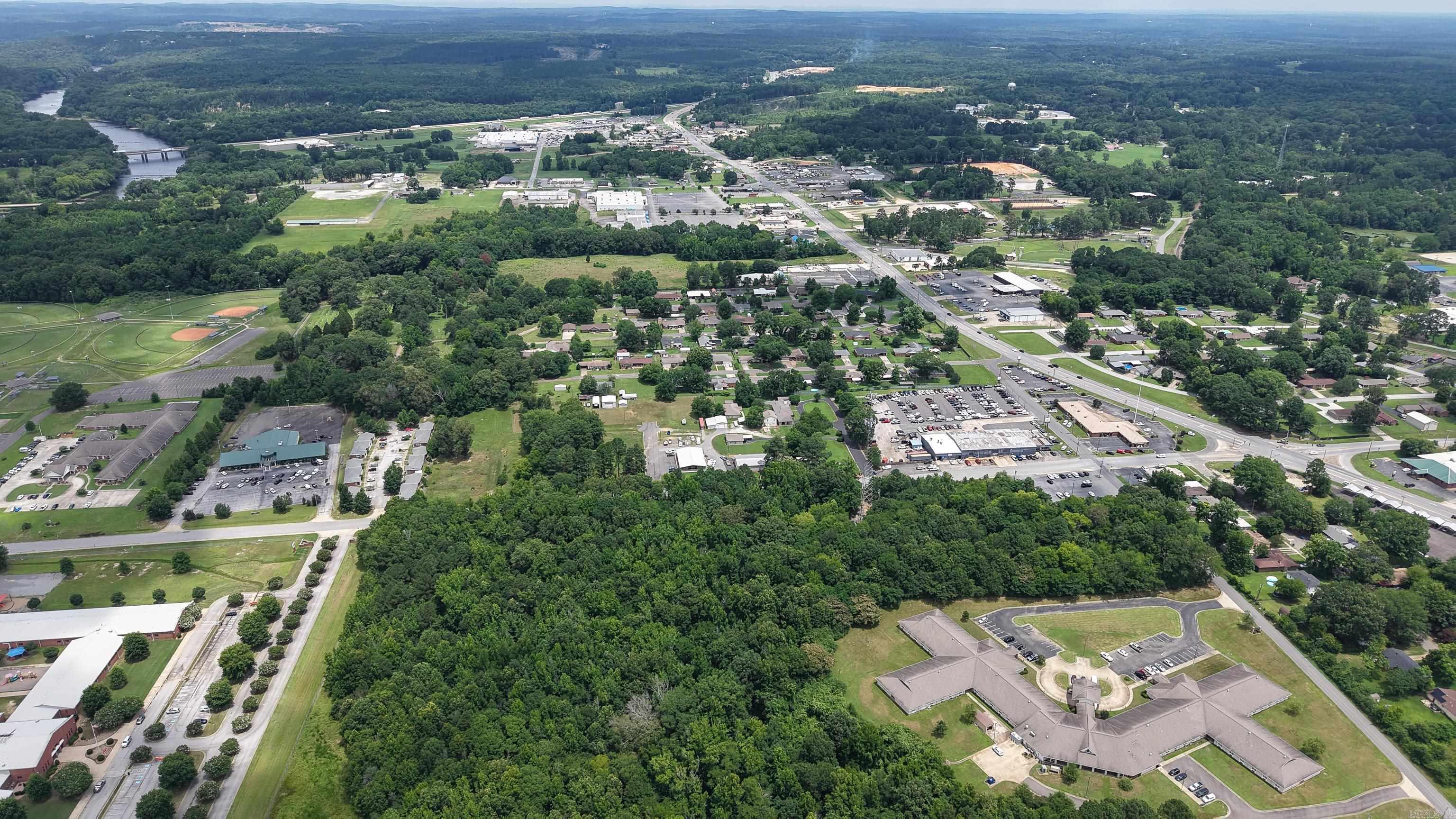 Prime commercial opportunity located inside city limits with excellent visibility and convenient access. This 4.73± acres offers utilities already on site and provides a great location for a variety of business uses. Positioned near a local school and along a well-traveled route with steady traffic exposure, this property offers strong potential for development. Take advantage of this versatile tract in a growing area with easy accessibility and valuable frontage.