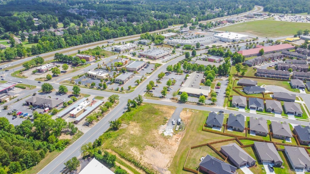 PERFECT LOCATION IN THE CENTER OF THE CITY OF MAUMELLE! EXCELLENT ROAD FRONTAGE ON BOTH CLUB MANOR AND CARNAHAN COURT!  WE WANT YOUR BUSINESS TO COME AND BUILD AT THE CORNER OF CLUB MANOR AND CARNAHAN COURT.  LAND IS CLEARED AND PAD READY.  WE CAN REFER YOU TO AN ENGINEER TO HELP YOU WITH YOUR DESIGN OR BRING YOUR OWN!  PROPERTY  BACKS UP TO  A NEW  SUBDIVISION WITH 59 HOMES AND IS CURRENTLY NEXT DOOR TO DOLLAR GENERAL, OFFICE STRIP MALL & ACROSS THE STREET FROM MANY FAST FOOD/RETAIL LOCATIONS! MAUMELLE IS EXPANDING THIS AREA AS PART OF THE CLUB MANOR CORRIDOR TO THE CENTRAL ARKANSAS GREENWAYS PLAN. ZONED PCD WITH A APPROVED VARIANCE OF  RESIDENTIAL UNITS PER ACRE.  ALL CLUB MANOR FRONTAGE MUST BE COMMERCIAL ON MAIN LEVEL.   CALL FOR AN ALREADY PREPARED PROPOSED DESIGN.  SEE PICS FOR THE PROPOSED DESIGN.
