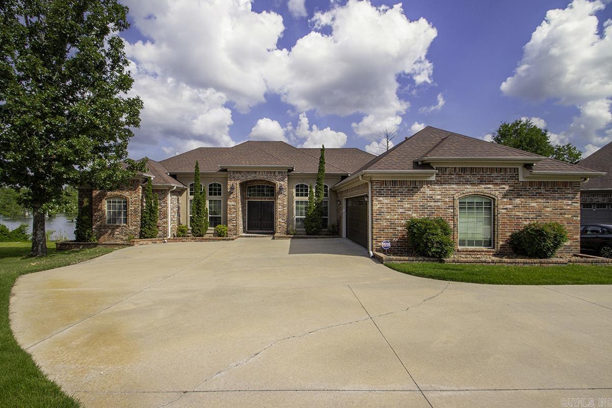 Unique find! This beautiful, custom home has a full view of Indianhead Lake, with water touching the back lot line all the way across the lot. Walk barefoot through the lush Zoysia grass lawn to enjoy sunsets and an expansive water view from the huge boat dock that conveys with this property.  Outdoor living is highlighted with an attached deck that's recently been redone with composite treads, (good longevity & no splinters!!).  Inside guests will be impressed with the tall ceilings and double front doors!  This home offers several additional spaces for privacy and function: an office, a sunroom and a sitting area in the primary bedroom, which would make a great work-out room, reading nook or nursery. This custom built, one owner home, is not only beautiful, but functions to suit many different family styles, with a split bedroom design, an open kitchen with upgraded professional appliances and a master suite that will make you 'never want to leave'!  You must see this home in person to appreciate all the upgrades, details and conveniences.  Schedule a showing today!!