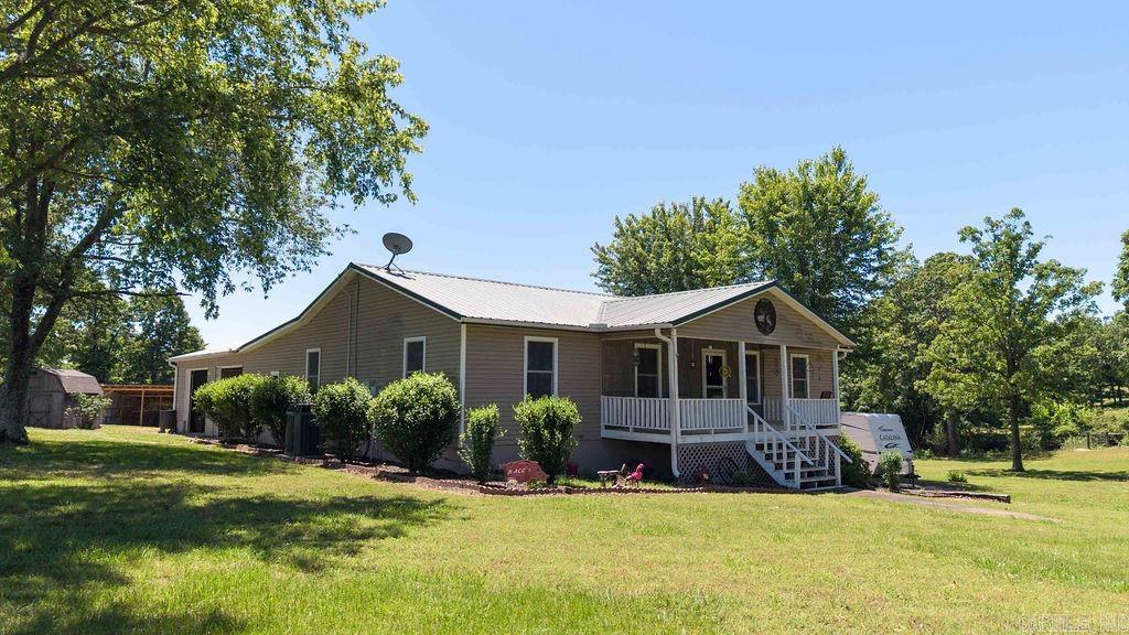 As you drive down the gravel driveway you come upon a charming country home that is nestled on 10.41 acres and immediately feel the peacefulness as you see the welcoming front porch and take in the countryside around you.  If you love the outdoors this property offers a pond, a garden site, implement shed with solar panels, cross fenced, fruit trees, 2 shops with plenty of room to expand, a place for your camper and plenty of room to hunt. The house boasts a large all seasons screened porch, a hot tub, an above ground pool with deck, large garage, wood stove along with central heat & air, heated flooring in primary bath, and a den for hanging out with family.   This one checks so many boxes!!!!