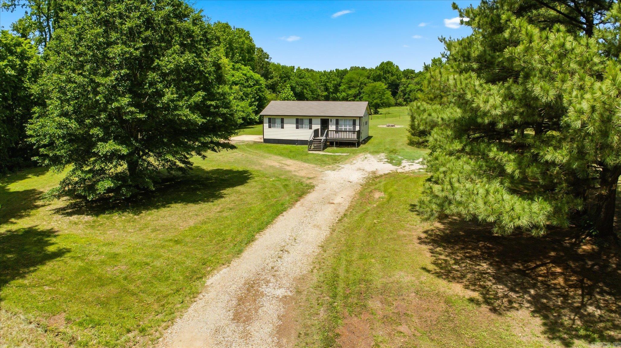 Welcome to Market: 423 County Road 111 of Bono, in Craighead County and the Westside Public School District. Do you love a house that’s plenty big enough to live in but not so big it becomes something you have to live for? How about a sprawling 1.3 acres mixed with the perfect blend of open space and tree cover? Welcome home. Everything about this property has been considered, optimized, and cherished. People didn’t just dwell here. They lived here. The front door opens onto the living room, with a walnut beam separating the living room and kitchen. The two rooms flow with the kitchen island doubling as the center point as well as a hub around which the home turns. Around the corner you’ll find your washer and dryer hookups with storage cabinets that match the cabinets and island in the kitchen. Don’t miss the bedrooms, sizable closets, and bathroom that continues the cabinet theme. The covered and screened-in back porch is a must see as well as the fire pit and wired shed. Nestled just north and west of Jonesboro, you are only 5.3 miles from the Parker Road Walmart Supercenter, 7.2 miles from Westside, and only 6 miles from downtown Jonesboro. Call to schedule your viewing today!