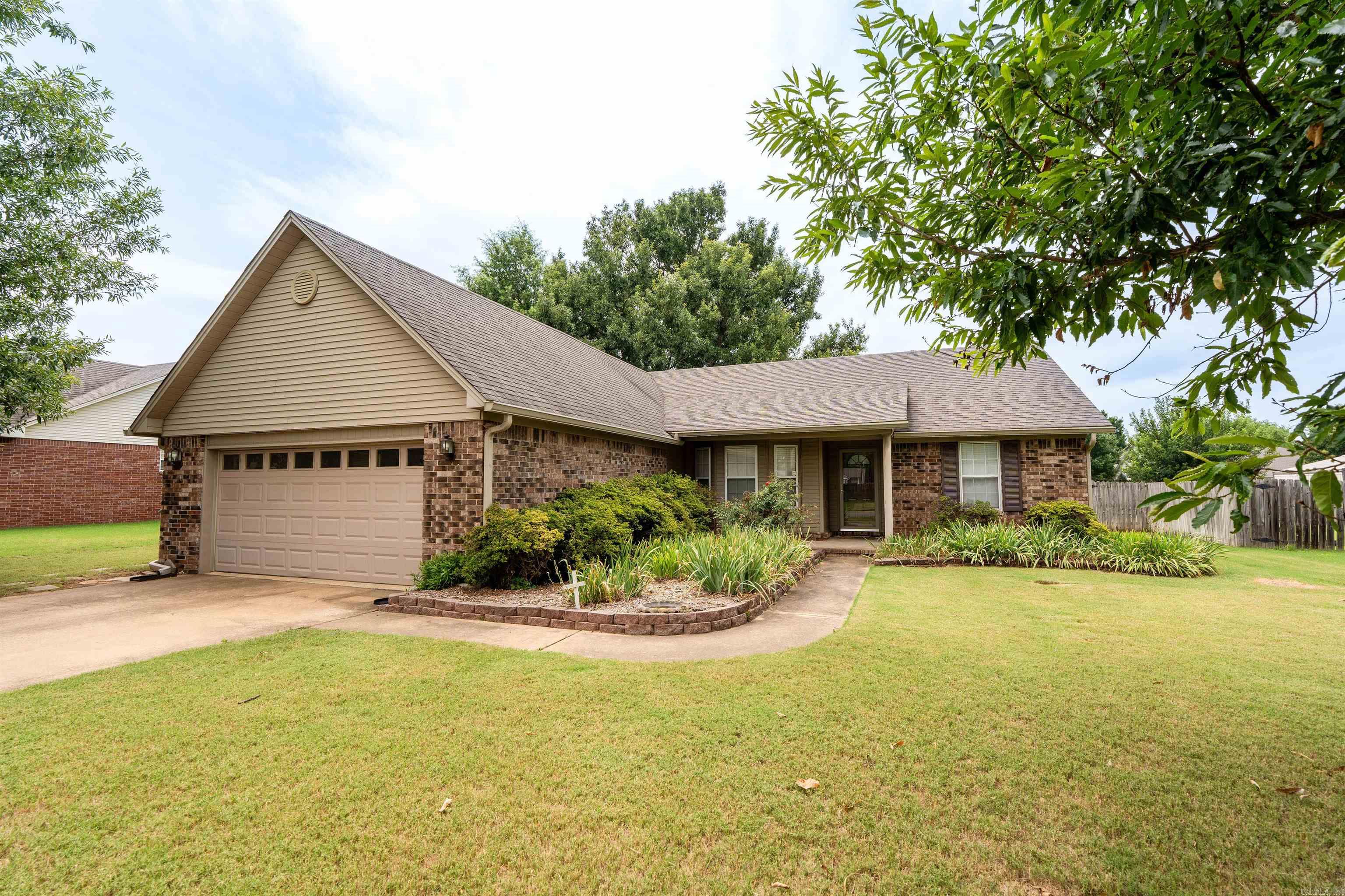 Spacious 3-bed, 2-bath home ready for new owners! This well-designed home features split floor plan with plenty of space for everyday living & entertaining. The separate formal dining room offers flexibility & could easily serve as a home office, while the kitchen includes an informal dining area & breakfast bar for casual meals. The kitchen is equipped with a brand-new stove/oven, a Bosch dishwasher, the refrigerator will remain with the home. A tray ceiling enhances the spacious feel of the living room, where you can enjoy cozy evenings by the gas fireplace. When the weather is nice, relax on the covered back patio, complete with new ceiling fans. Additional features include faux wood blinds throughout, fresh interior paint, an abundance of storage with extra closets. The security system includes two control panels, one conveniently located in the primary bedroom. The spacious primary suite offers a large walk-in closet & an en-suite bath featuring a double vanity, separate jetted tub, and shower. You'll also appreciate the oversized laundry room with cabinets & a hanging rack for added convenience. Updates include water heater & HVAC system installed in 2023, roof less than 9 yr
