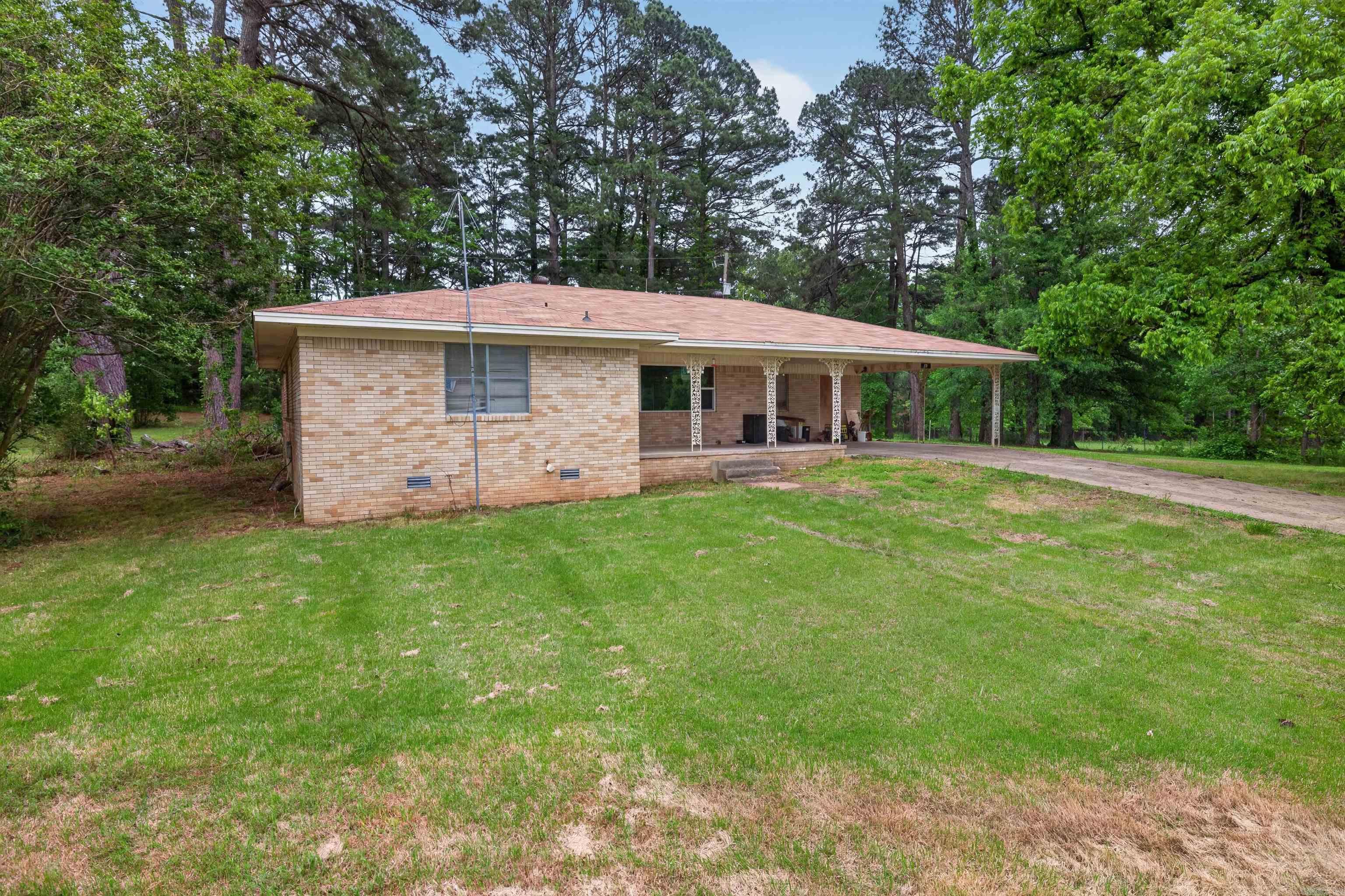 This wonderful maintained 3-bedroom, 2-bath home sits on 2.56 peaceful acres. Inside, enjoy a bright living area, a functional kitchen with plenty of storage, and a primary suite with a private bath. Two additional bedrooms offer space for family or guests. Outside, the expansive yard is ideal for gardening, recreation, or relaxing in privacy. A covered carport and storage shed add convenience. Roof replaced in November of 2023. This home offers a quiet retreat—schedule your private showing today! *Agents see remarks