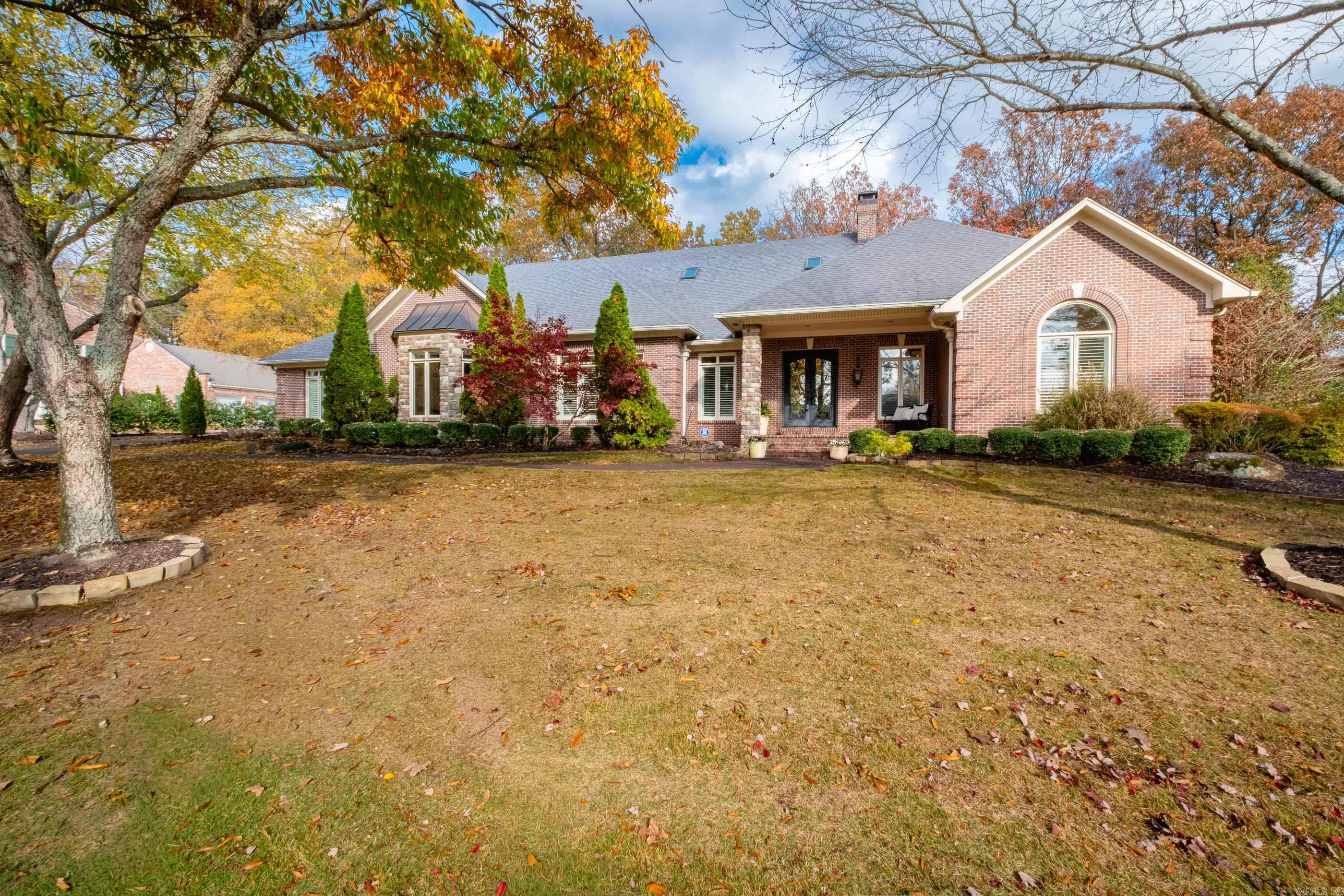 This stunning custom home on the prestigious Founder's Course of Chenal blends timeless elegance with everyday functionality.  Enter through striking iron and glass doors into an open floor plan ideal for both family living and entertaining.  The living room features exotic wood floors, a beautiful fireplace, and sweeping golf course views.  Just off the foyer, the formal dining room flows into a spacious kitchen with a center island high-end appliances, and a cozy informal dining area.  A family den with it own fireplace opens to a large brick patio, perfect for outdoor gatherings.  The main level offers a luxurious primary suite, a guest suite with walk-in closet, and a flexible office or media room complete with a half bath and wet bar.  Upstairs, enjoy a generous game room and three additional bedrooms, each with direct bath access.  Recent updates include fresh neutral paint. The beautifully landscaped yard features a tranquil water element, and the home is complete with a three-car side-loading garage with storage and a separate golf cart garage....driveway has direct cart path access to the golf course!