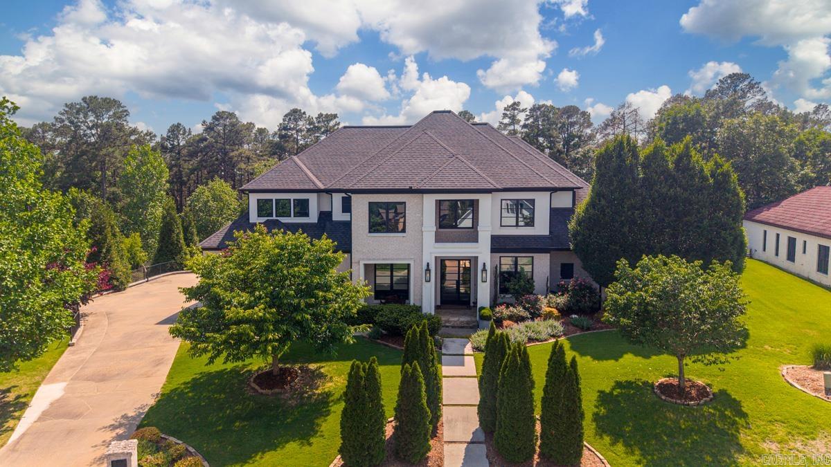 Located in the highly desirable Chenal area of West Little Rock, in Sezanne Court is a beautifully designed luxury residence offering 4 bedrooms, 3 bathrooms, sophisticated living spaces, and exceptional indoor-outdoor entertaining. This stunning home features a grand entryway, chef’s kitchen with double islands and premium appliances, elegant primary suite on the main level, dedicated office and dining room, along with a resort-style backyard complete with a pool, outdoor kitchen, fireplace, and professionally designed landscaping by Chris Olsen. Thoughtfully designed with timeless finishes and upscale amenities throughout, this home perfectly blends luxury, comfort, and functionality. AI was used in some pictures for virtual staging.  Agents PLEASE see remarks before requesting showing.