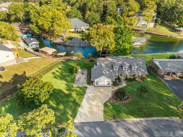 LAKE HAMITON!! Close to everything, downtown Hot Springs, Oaklawn , restaurants and shopping. Home has been totally updated, also has added another Primary bedroom with its own bath. Other two bedroom share a bath. LVP flooring, kitchen has island with new countertops, granite and appliances. Kitchen over looks great room with fireplace. Has extra parking and large side yard. Beautiful covered back porch overlooking lake with boat dock.