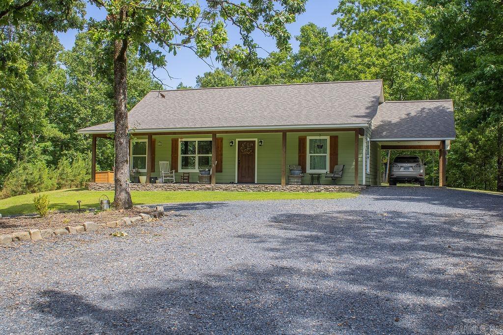 Country privacy, a newer home, 5 acres, and a shop, this property checks all the boxes. Tucked down a quiet dirt road with a hidden driveway, this beautiful home at 131 Polk Road 295 in Hatfield offers the peaceful country setting so many buyers are searching for. Sitting on 5 acres, the property provides privacy, seclusion, wildlife, and room to breathe, while still being close enough to town for convenience. Inside, the home features 2 bedrooms, 2 full bathrooms, plus an office that offers flexible use and could be used for 3rd bedroom. Built by the well-known Walker Construction out of DeQueen, the home includes quality touches throughout, such as vaulted ceilings, granite countertops, larger baseboards, upgraded door trim, timber beams, and a warm custom feel. Outside, enjoy the covered front porch, open space, and a shop, making this a rare find for anyone wanting acreage, comfort, and country living.