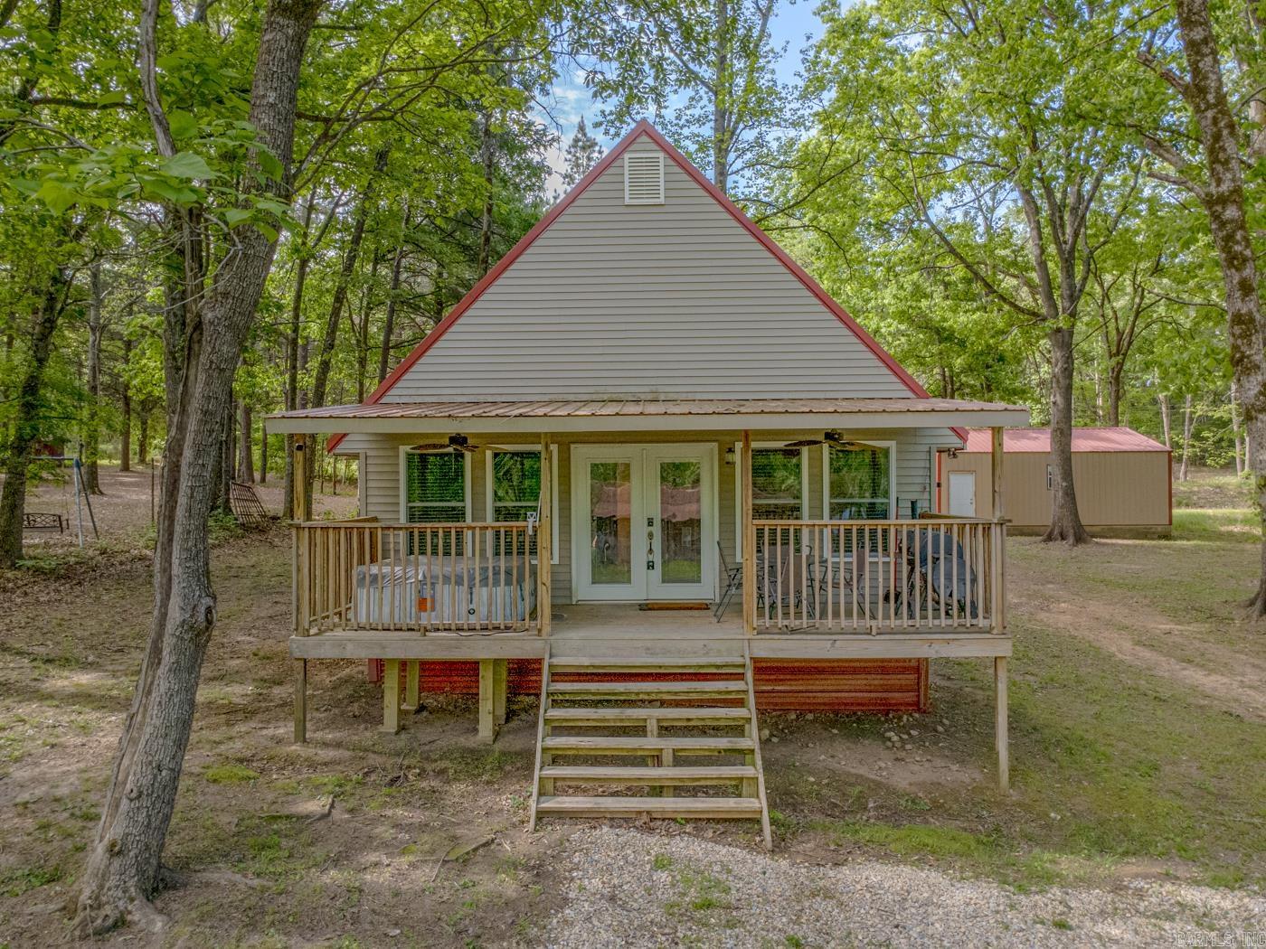 Welcome to 1815 Stubblefield Rd in Pocahontas, AR. This is a charming, fully furnished getaway just a short walk from the Eleven Point River. This 2-bedroom, 1-bath property also features a spacious loft that comfortably fits two beds, allowing the home to sleep up to 7-10 guests comfortably.  This property is surrounded by vacation rentals in a highly desirable recreational area. A private community boat ramp is available to land owners for easy river access, and an additional 0.22+\- acre riverfront lot is also available for purchase depending on the offer, perfect for buyers wanting even more space or future investment potential. The home offers low-maintenance living with a metal roof, vinyl siding, and metal underpinning. A large attached 20x30 shop with two garage doors provides ideal storage for kayaks, boats, fishing gear, and river floats. Sitting on 0.30 +\- acres, this property is an excellent opportunity for a full-time residence, weekend retreat, or continued short-term rental use. Furnishings are negotiable, and the property can remain turnkey for the next owner. Call to schedule your showing today.