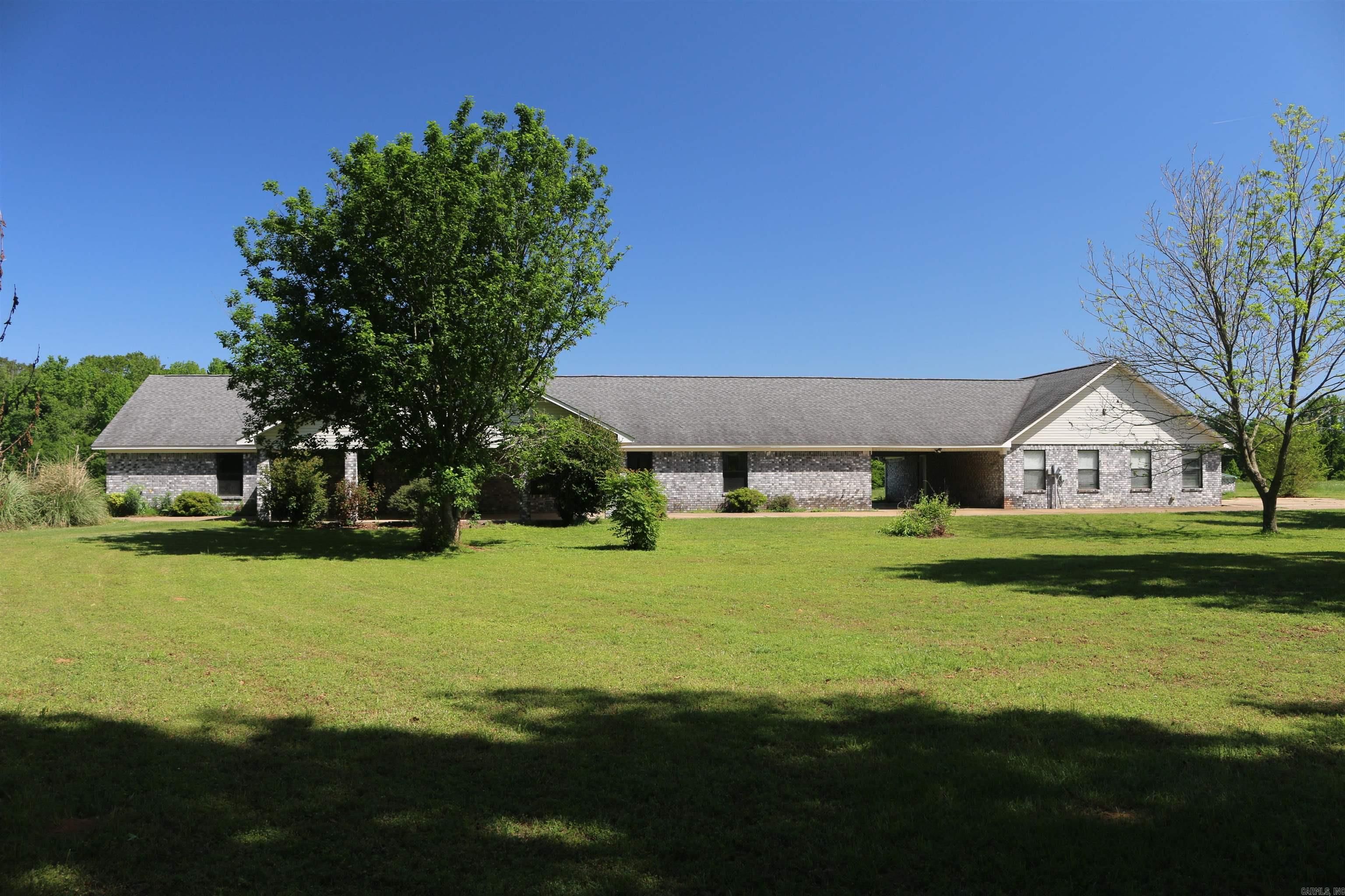 This 59 +/- acre tract is nestled just outside of Nashville, Arkansas. This big & spacious 3 bd, 2 bath home with an exceptional great room for entertaining family and friends, the newer roof was established along with 2 newer HVAC units and new flooring in the great room & new water heaters. The big kitchen, dining room, and very spacious master bed and bath has got you covered on space. With a breezeway headed to the oversized 2-car garage that has a bathroom in it as well, it's easy to unload those groceries in the weather. The wood-burning fireplace makes it extra cozy during the colder months for those long evenings inside. The property has great native grasses growing on the tract that would make this an ideal area for some extra fencing to let them horses roam and have plenty of room to run. Having a 1,200 square foot shop on a slab with power, you can work on tasks, tractors, or whatever needs to be done. The property also has an amazing multi-spring-fed 2 +/- acre stocked pond as well that has some great fishing in it. This beautiful home and acreage is definitely one of a kind. Just a few short miles from Millwood Lake, & 3 miles from Walmart supercenter and town.