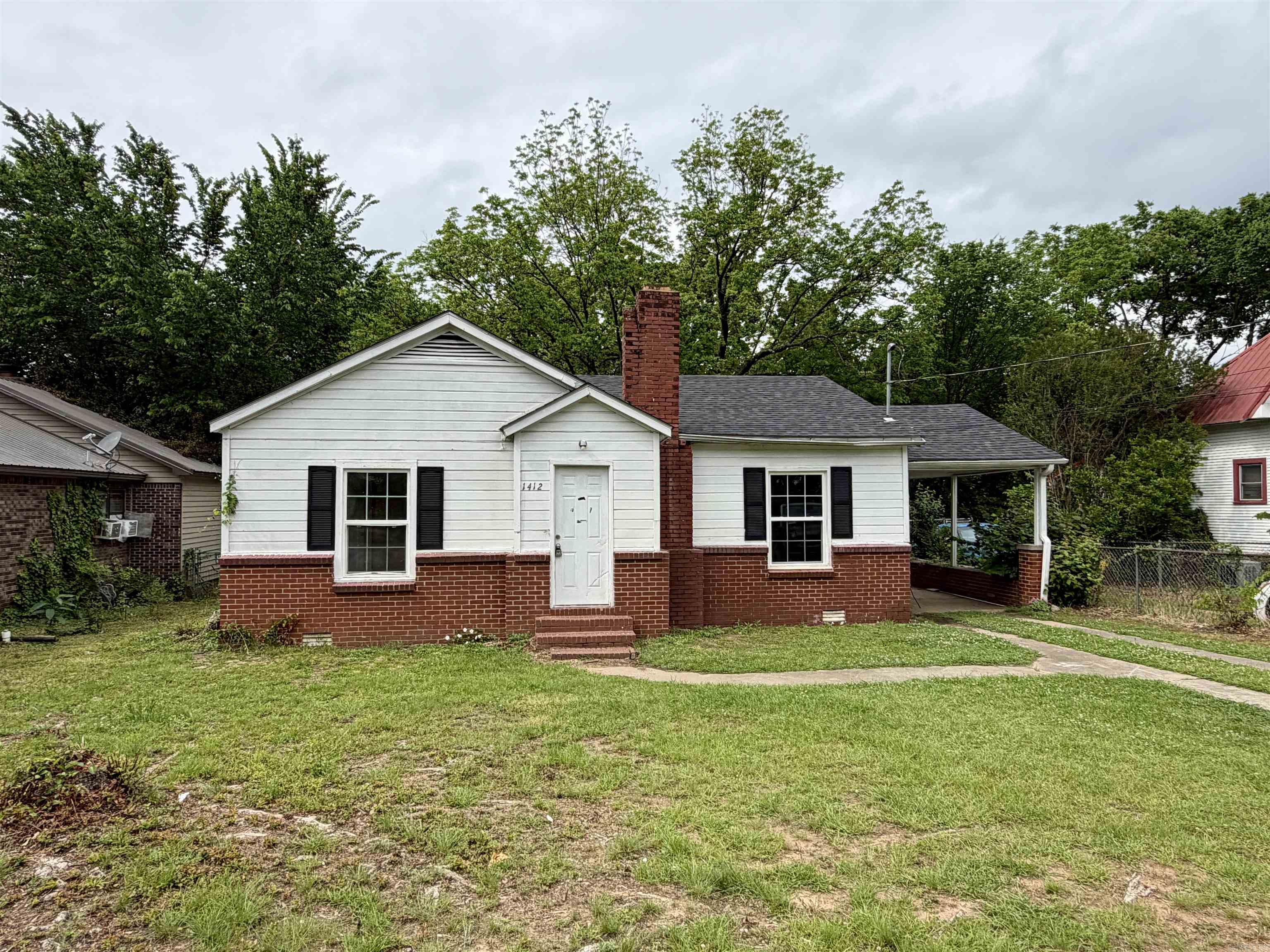 Recently remodeled charming bungalow featuring covered parking and a peaceful wooded backyard with large shade trees. Inside, you’ll find a spacious living area centered around a fireplace, along with a large eat-in kitchen complete with freshly painted cabinets and a new electric range. Numerous cosmetic updates throughout include fresh paint, new light fixtures, updated flooring, and new vanities. Additional improvements include a new roof and gas hot water heater, making this home move-in ready with both character and modern updates.