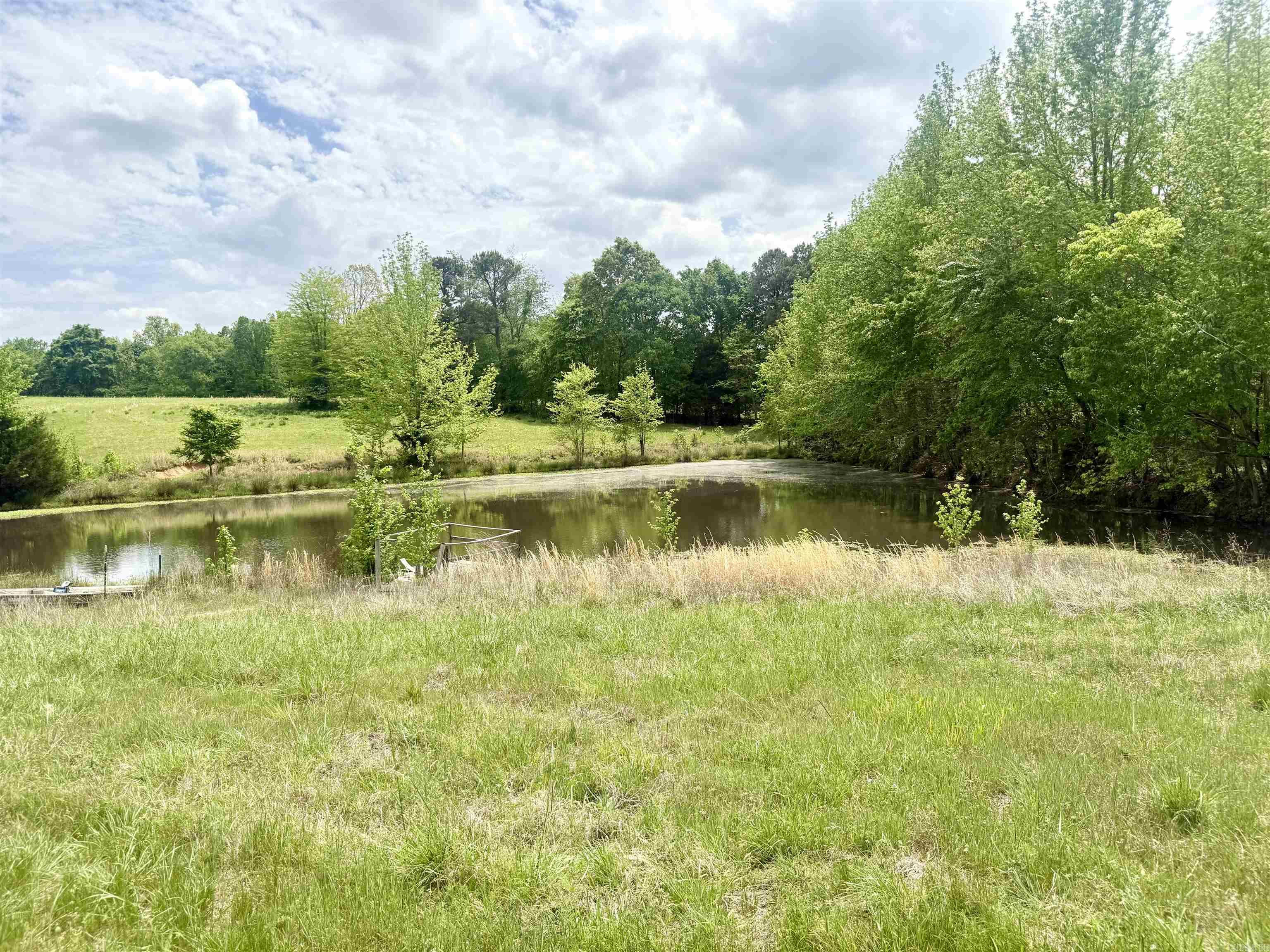 Absolutely stunning property!! This 73.22 tract provides gentle rolling hills with a pond and a year-round creek. It is already fenced for cattle, and there are also several great building spots. This property has a great mix of woods and pasture- great for building your dream home and/or running cattle!