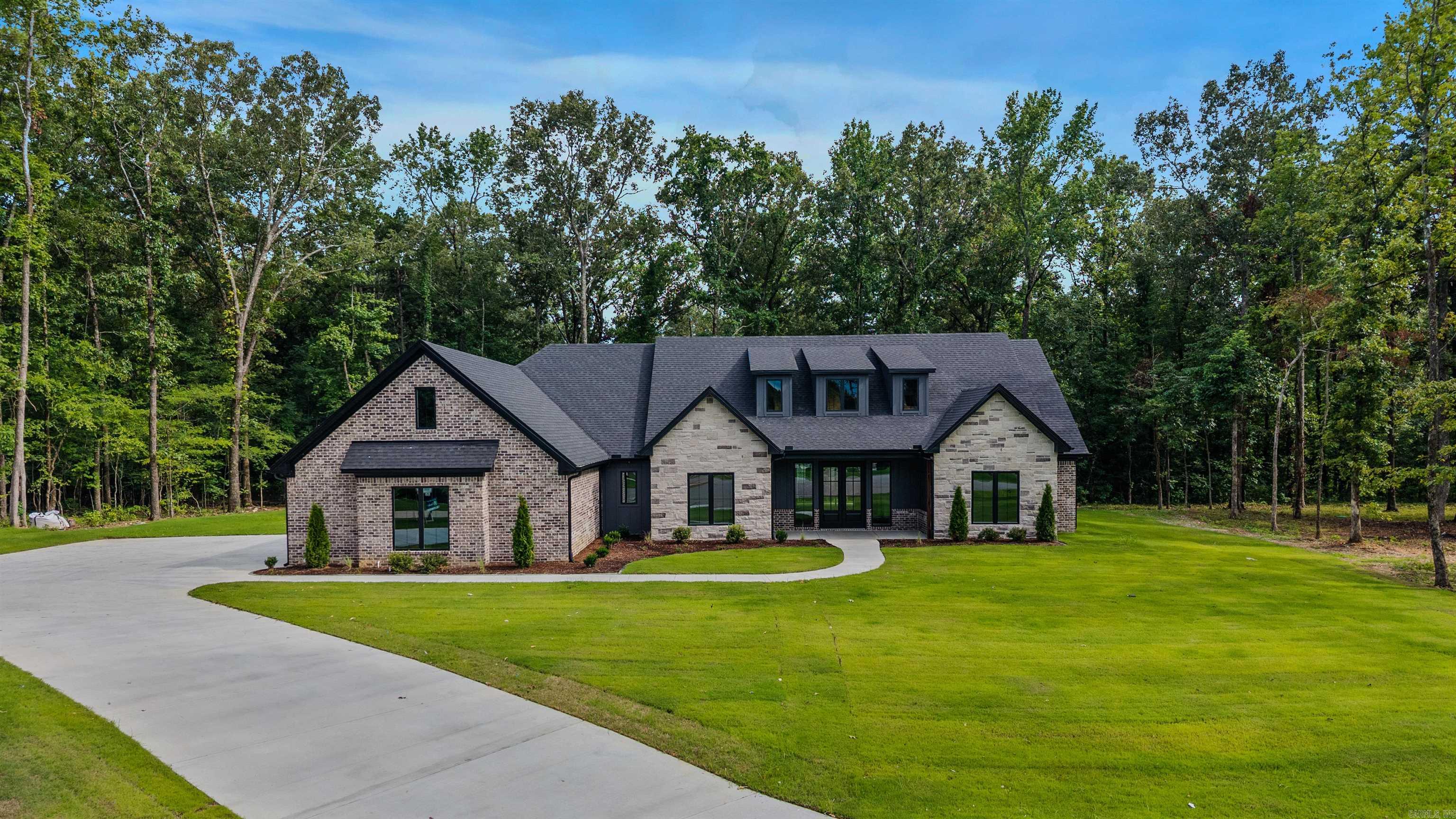 Beautiful new construction in one of Saline Counties newest neighborhoods Avilla Manor.  This home sits off of a 1/2 cul-da-sac on 1.15 acres with plenty of room to stretch out, this home boast some wonderful features such as wide open floor plan, with big sliding glass door to go out to the back porch.  Custom cabinets, with built-ins.  The primary bath is made for a queen with a open air shower and a closet that is to die for..  This home has it all set up your appointment today.