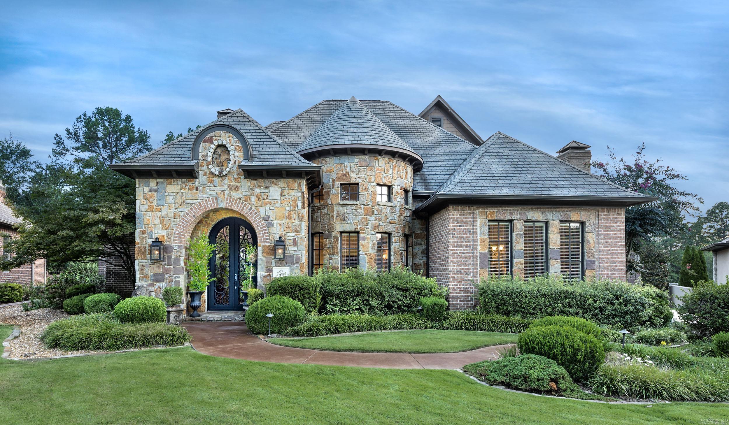 This stunning home is designed for both entertaining and effortless living. A spectacular two-story entry opens into the formal living room, where walls of windows overlook a gorgeous in-ground pool, tranquil water feature, outdoor fireplace, and a large covered patio. The private, level backyard creates the perfect backdrop for gatherings of any size.  The spacious den connects seamlessly to the eat-in kitchen, featuring two pantries, a Viking 6-burner cooktop, wall ovens, a cozy fireplace, bar, icemaker, and wine refrigerator—everything needed for cooking and entertaining in style.  On the main level, you’ll find the luxurious primary suite, a guest bedroom, home office, formal living and dining rooms, 2.5 baths, and a full laundry. Upstairs offers even more space with a media room, additional bedroom, and full bath.  Located in The Arbors, a gated neighborhood where all lawn maintenance is included, this home offers convenience as well as beauty. With easy access to the country club and all the amenities of Chenal Valley, this property combines privacy, elegance, and lifestyle in one remarkable package.