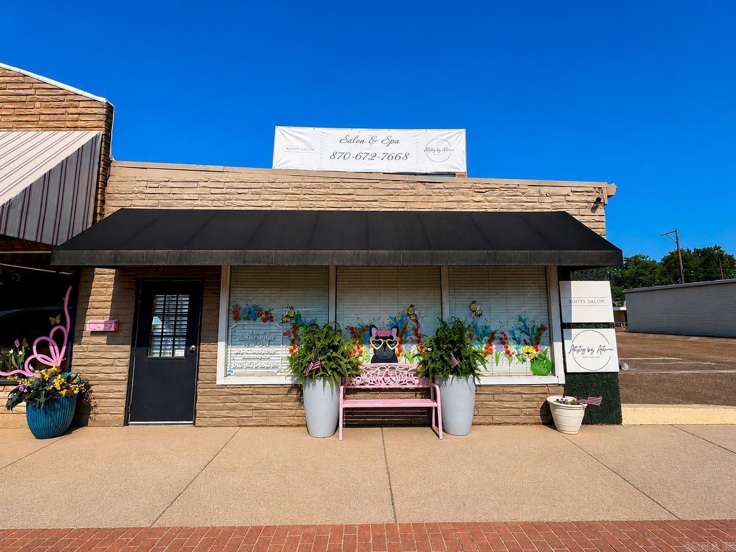 Prime Commercial Opportunity in the Heart of Downtown Stuttgart!  Position your business for success with this versatile 2,400± square foot commercial property located on Main Street in Stuttgart's downtown business district. Offering outstanding visibility and convenience, the property features both street parking for customers and a private on-site parking lot.  Inside, you'll find a bright and inviting open-concept with a reception area a welcoming first impression for clients. The flexible layout includes four private rooms that can easily serve as offices, treatment rooms, or client service spaces, making it ideal for a variety of professional or retail businesses.  Previously designed for salon use, the building is already plumbed for salon services, while the functional floor plan also includes two restrooms, a storage room, and a kitchen with laundry hookups. The stylish open ceiling adds a modern industrial touch, giving the space character and a polished finish.  Additional features include:  2,400± heated and cooled square feet All-electric utilities Attractive front awning  updated electrical