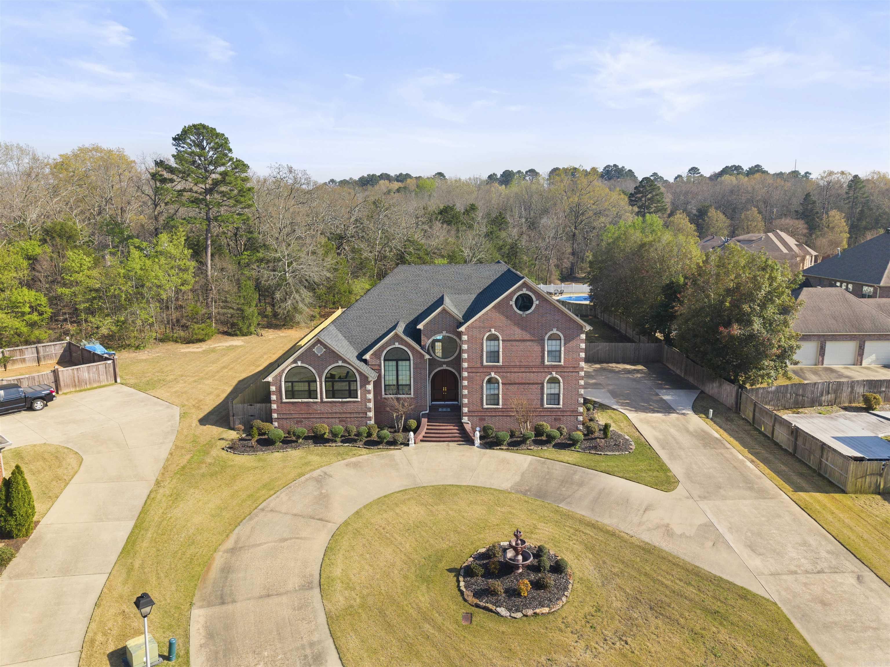 One owner Custom-built home by Bobby Wooten offering approximately 4,695 sq ft of living space.This home features 6 bedrooms  and 4.5 bathrooms. The living room features a 23-foot vaulted ceiling, skylights, gas log fireplace, and built-in cabinetry. The kitchen, living, and dining areas are connected with an open design and include a new stove and microwave. The owner’s suite includes a walk-in closet, built-in storage, jacuzzi tub, and walk-in shower. A guest suite features a vaulted ceiling and jacuzzi tub. Upstairs includes a large game room and third-floor loft, providing additional space for a variety of uses. Exterior features include a 16x24 in-ground pool with a Hayward automatic cleaning system, and a 10x10 pool house with bathroom and outdoor shower.