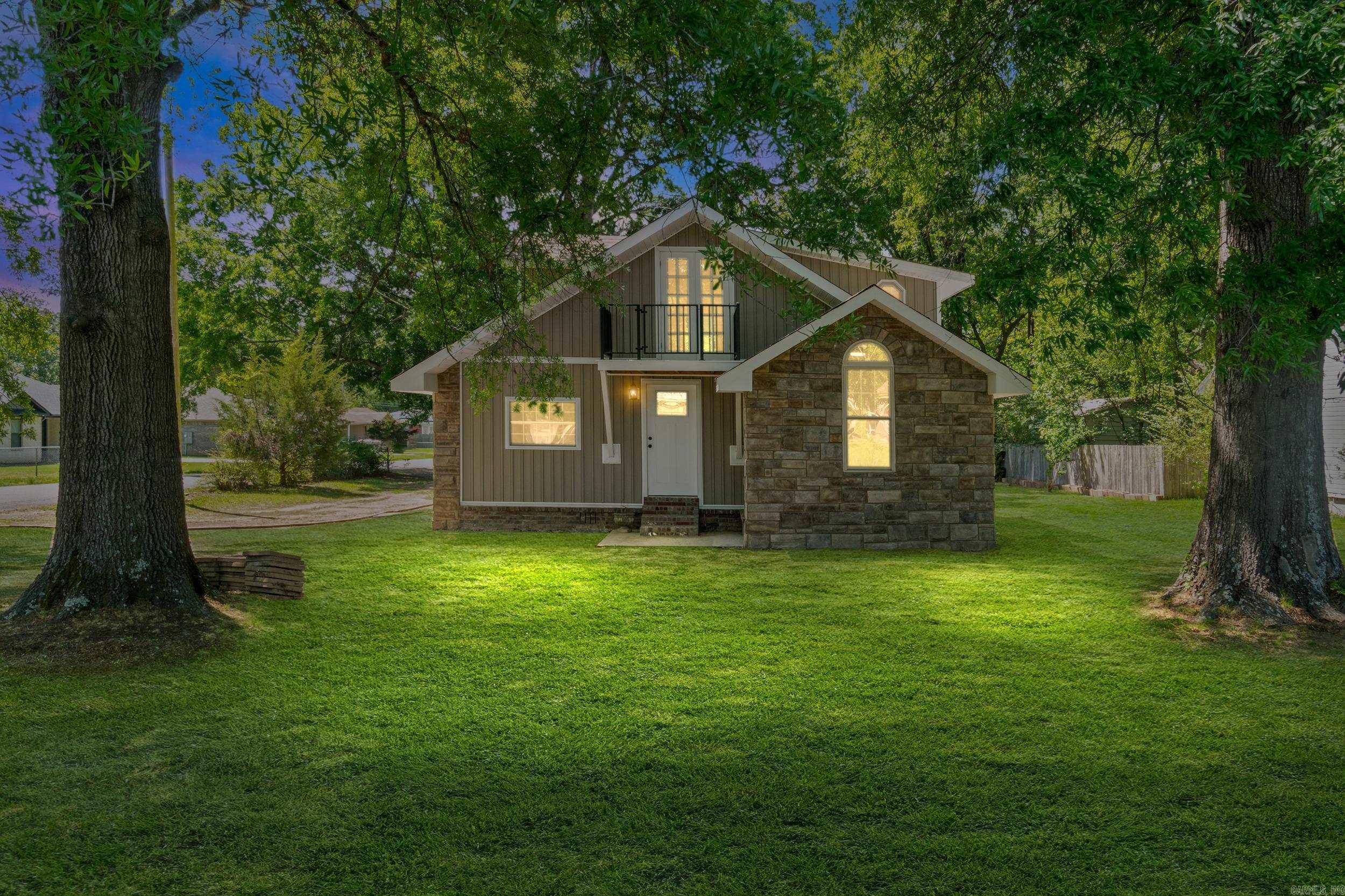 This super cute and very unique home has been completely remodeled inside and out. Outside features new rock, siding and new roof, inside you'll find new stainless steel appliances, new cabinets with quartz countertops, mini split heat and air, recessed lighting, laminate floors in the living area, kitchen and both bathrooms. Downstairs features your primary bedroom and bath, upstairs you will find 2 more bedrooms with new carpet, bathroom with soaker tub, and a large open versatile space that could be used as a gameroom, office, sitting area, etc. You'll also find access to your very own private balcony to sit and enjoy the outdoors.  Some photos have been digitally enhanced. Measuring is encouraged.