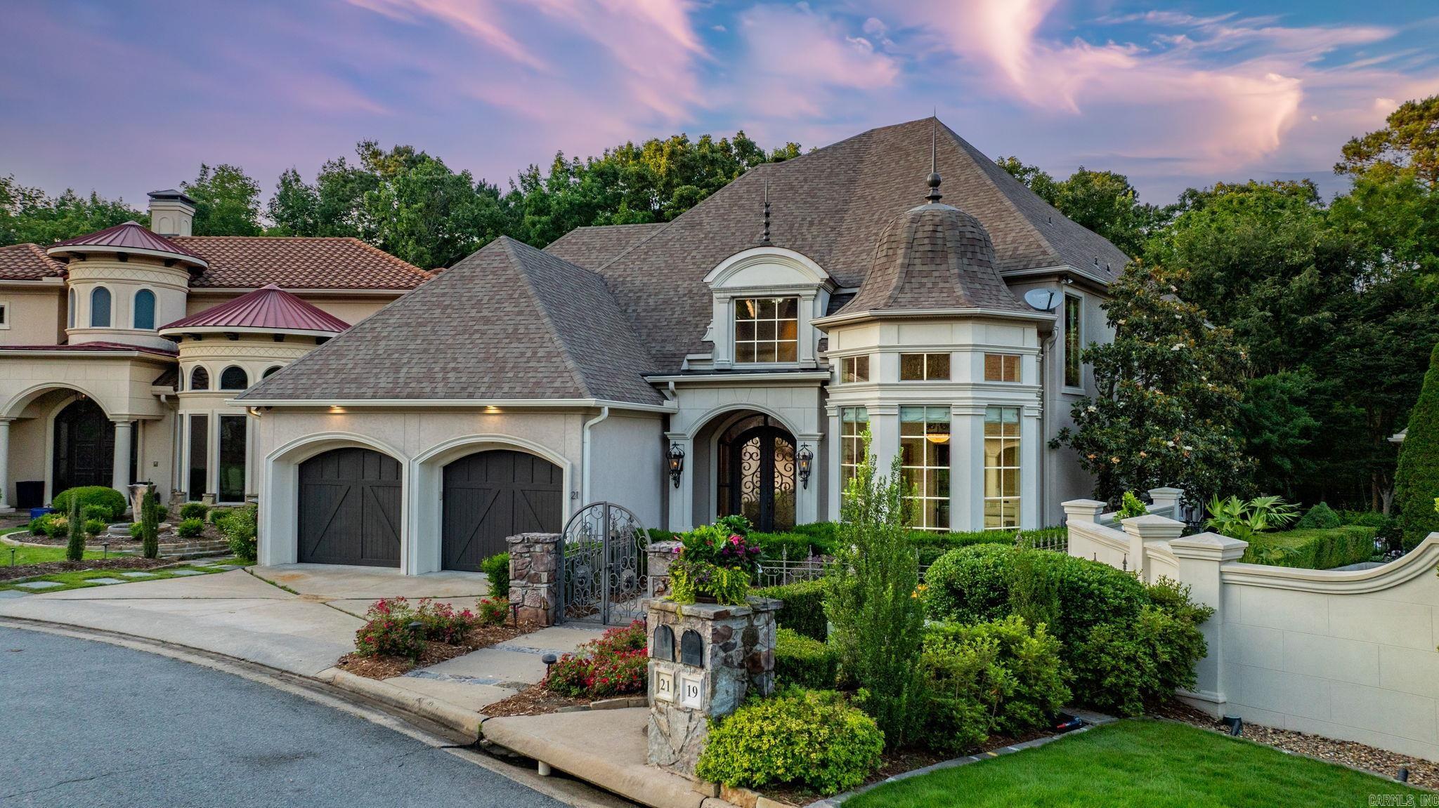 Welcome to this stunning residence in the sought-after LaScala area of the gated Hickory Grove community. Once a Symphony Designer House, this home is filled with custom details. POA handles the yard service. Enter through a gated courtyard & covered front patio, where elegant iron doors lead into a grand foyer with tall ceilings. The home’s open floor plan is light-filled & the living area has expansive windows overlooking backyard. The gourmet kitchen has premium appliances, a spacious island with storage & designer lighting. Adjacent to the kitchen is dining area, highlighted by a custom James Hayes chandelier, complemented by a piece in the nearby wet bar. The main level includes primary suite with a dream-worthy walk-in closet & luxurious marble bath featuring double vanities, soaking tub & walk-in shower. Also on this floor is a bright, freshly painted office with ample storage, family room, half bath, & laundry for added convenience. Upstairs you’ll find a generous 2nd living area with wet bar, 2 ensuite bedrooms, & versatile third bedroom that could be a home gym. Additional highlights: extensive storage, Elan smart home sytm with 7 TV's that convey. Gorgeous outdoor areas!