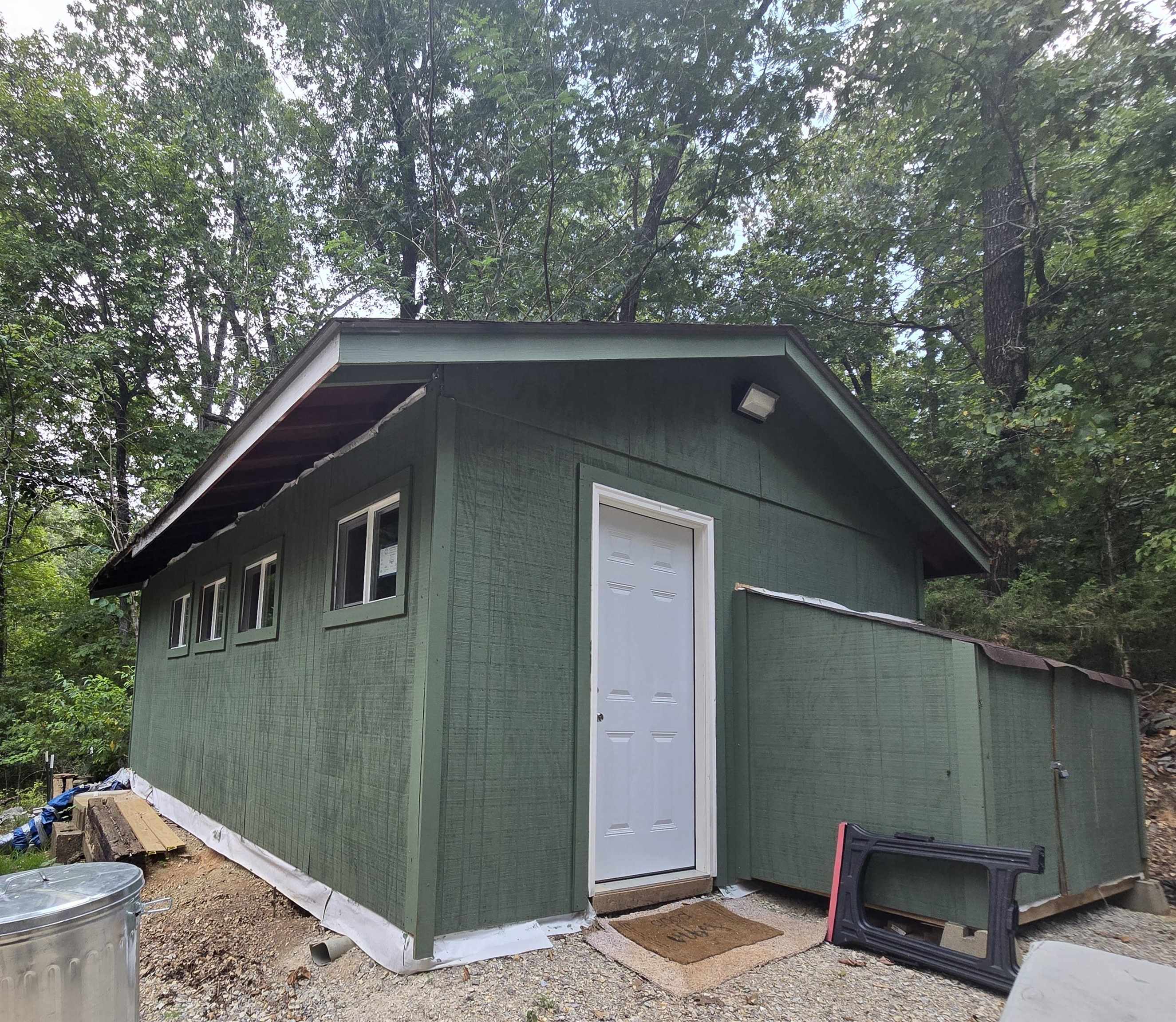 Located in the quiet Hidden Valley area of Highland, this cozy and functional cabin offers a unique opportunity for privacy and potential. Set on a low-traffic road with no nearby neighbors, the property provides a peaceful, tucked-away setting ideal for those seeking a more secluded lifestyle. The cabin features a living area, kitchen, and a bathroom complete with a shower and toilet. It is currently livable and in working condition, while the unfinished interior allows for customization to suit your style—whether you’re envisioning a simple rustic retreat or a more polished finish. Heating is provided by a propane heater, and cooling is handled with a portable air conditioning unit. The property also includes the remains of a previous home’s foundation, offering additional possibilities for future building or expansion. With a little vision, this property has the potential to become a great weekend getaway or full-time residence.