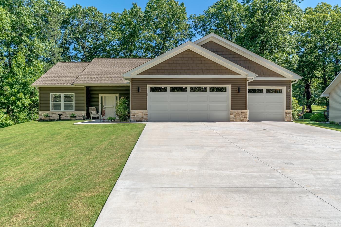 Welcome to Market 59 Tohatchi Dr. in Cherokee Village, AR. Situated on .26 +/- acres overlooking the South Golf Course is a 2023 built, 1 level, one-owner home offering 1,630 sf of living space, no step design, and golf course views. Wrapped in vinyl siding w/ GenStone accents, topped w/ architectural shingles, and accented by Pella windows, a 3 car garage, covered entry, Bermuda grass, low maintenance exterior, and a 543 sf outdoor living area w/ both covered and open-air patio space. The interior holds 3 bedrooms, 2 baths, 9 ft ceilings, LVP flooring, recessed lighting, and an open living, dining, and kitchen layout filled w/ natural light. The custom kitchen features granite countertops, custom cabinetry, under cabinet lighting, gas range, stainless appliances, island w/ bar seating, and walk-in pantry. The primary suite includes a large bedroom, en-suite, and walk-in closet. You’ll love the outdoor living space overlooking the golf course, 833 sf garage area, HE heat pump w/ propane backup furnace, water heater, water softener, and NEXT fiber internet. All window coverings, mounted TVs, and appliances convey at no value. Call today to make this golf course house your home.