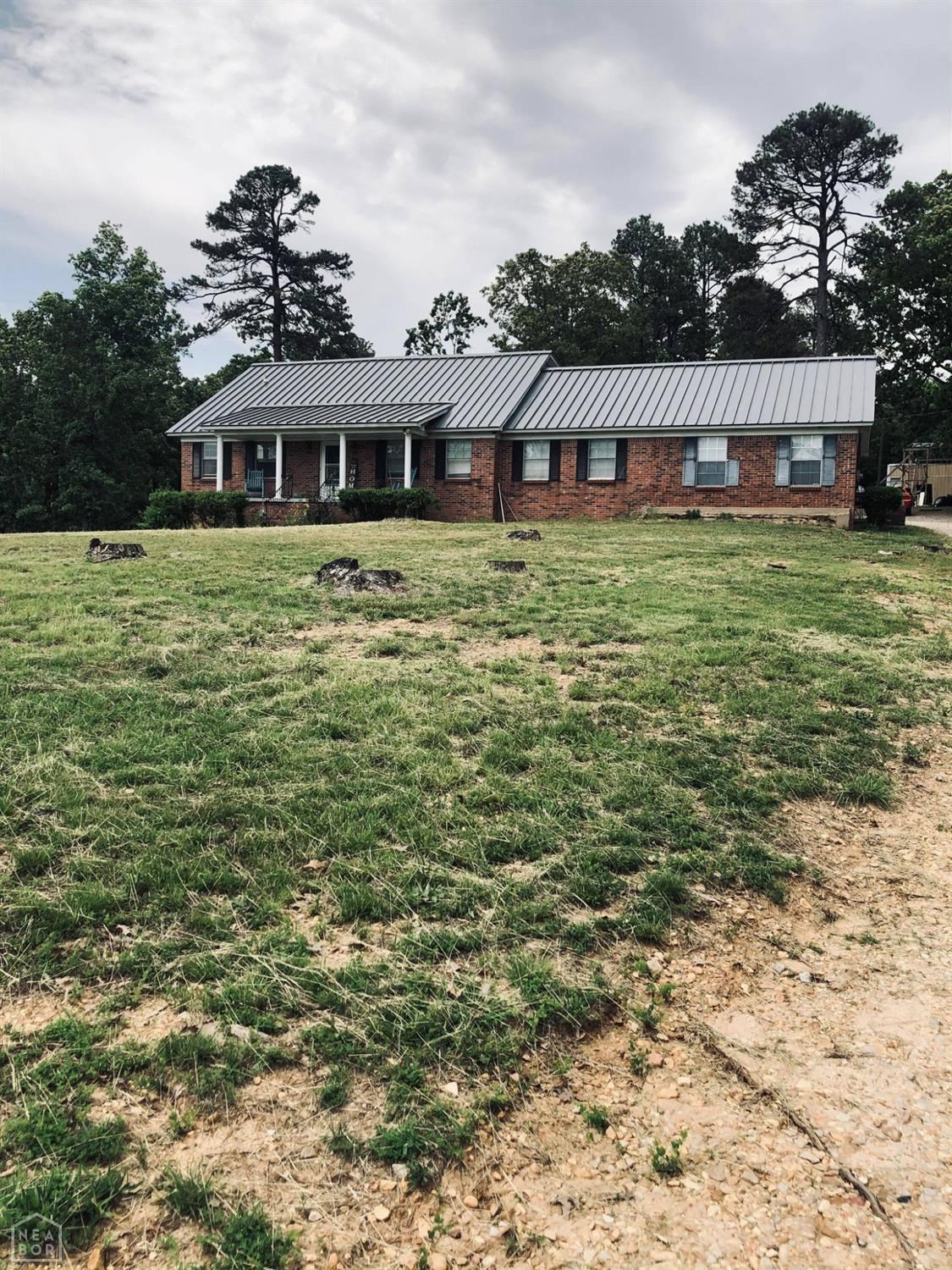 Large 5 bedroom 2 bath brick home on 3.78 Acres +/- with a shop and fish pond. Recently remodeled. Home has all the boxes checked. New A/C system, New Roof, New countertops and cabinets. New appliances. New Flooring, New Paint. Custom tile shower and bath. New deck with a beautiful view overlooking the pond. Large 5th bedroom could be used as a bonus room, second living room or office. Motivated Seller!! Small storage building by pond does not convey with property.