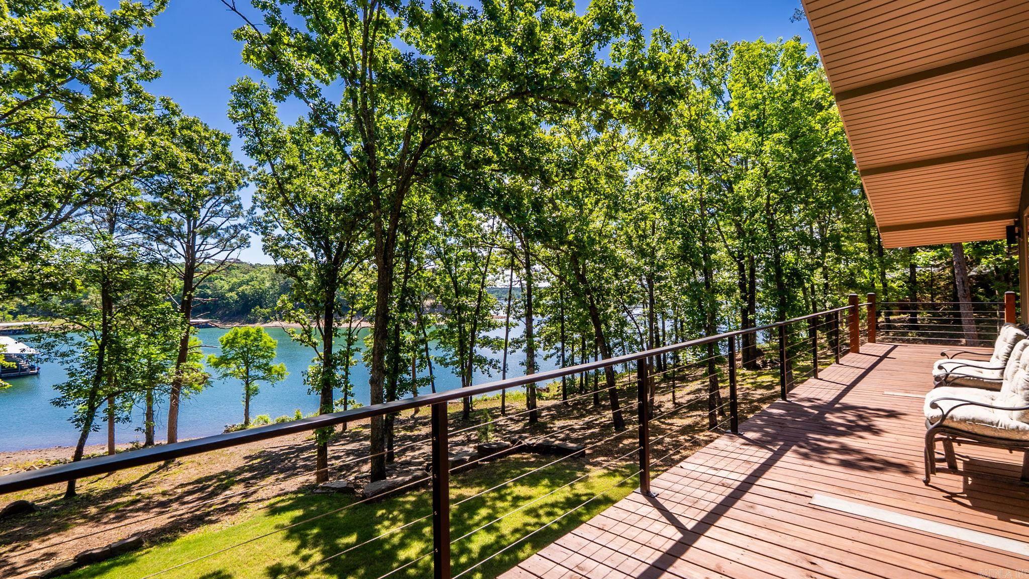 LAKE FRONT, LAKE VIEW with Property Line in GREERS FERRY LAKE and located in Fairfield Bay, but with no FFB dues or restrictions. This is truly a rare gem that has been striped to the framing a rebuilt with all new everything. The location on the lake is fantastic with an easy walk to the water and within kayak distance of Sugar Loaf Mountain and watch the FFB Fireworks from the water just outside the cove. with 5 bedrooms, 3 bathrooms, a full kitchen & living on one level and a kitchenette and 2nd living area on the other level, this could accommodate a large group/family for personal use or a short-term rental. Don't miss this opportunity.