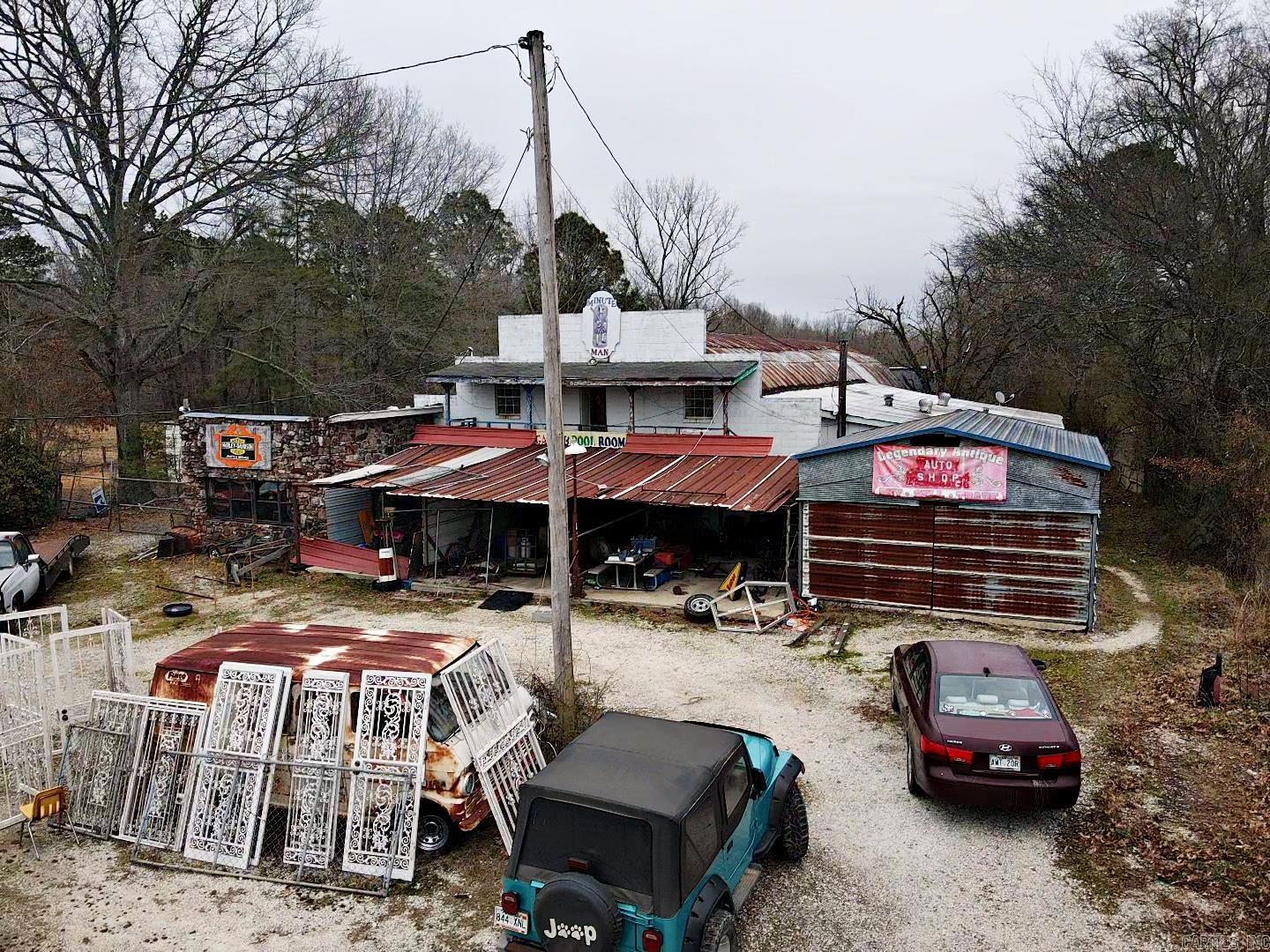 Endless possibilities with this SPACIOUS COMMERCIAL property. Highly visible location with heavy traffic count. There is an office, a loading dock and tons of storage space. Also included is a 2 BR/1 BA mobile home with a porch. Property includes the building, acreage, and mobile home only. Building contents and items on the exterior and yard DO NOT CONVEY! BEING SOLD AS IS! CALL TODAY!