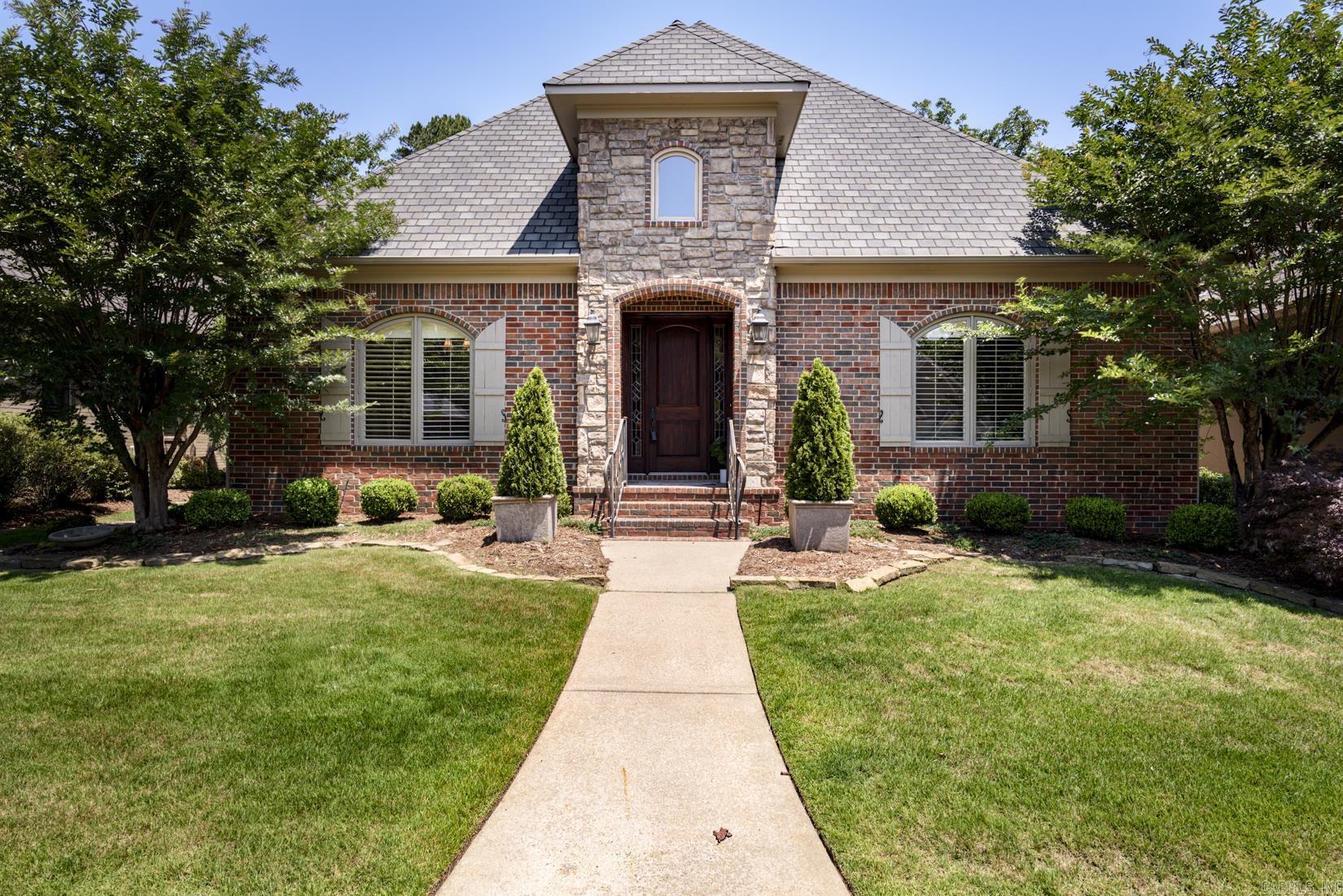 Well maintained one level home in the gated Oaks neighborhood where lawns are maintained by the POA. The inviting foyer has slate floors and deep crown moldings. To the left is a Formal dining room with maple floors and a butler's pantry with granite countertops. The kitchen has stainless appliances, a walk in pantry, under counter lighting and abundant cabinetry, a great place to display collectibles and china. A cozy sitting area provides a great place for enjoying morning coffee. The hearth room is open to the kitchen/breakfast area and has a fireplace. Just outside is a covered patio. The primary suite has a walk-in shower as well as a jetted tub and generous walk in closet with safe. There are 2 other bedrooms and one has built-in desk and file cabinets. A powder bath is located of the foyer as well as nice size laundry room with sink. Pretty light fixtures, plantation shutters, security system, walk up attic storage with rear load garage make this home a great place to live. Call today for a showing.
