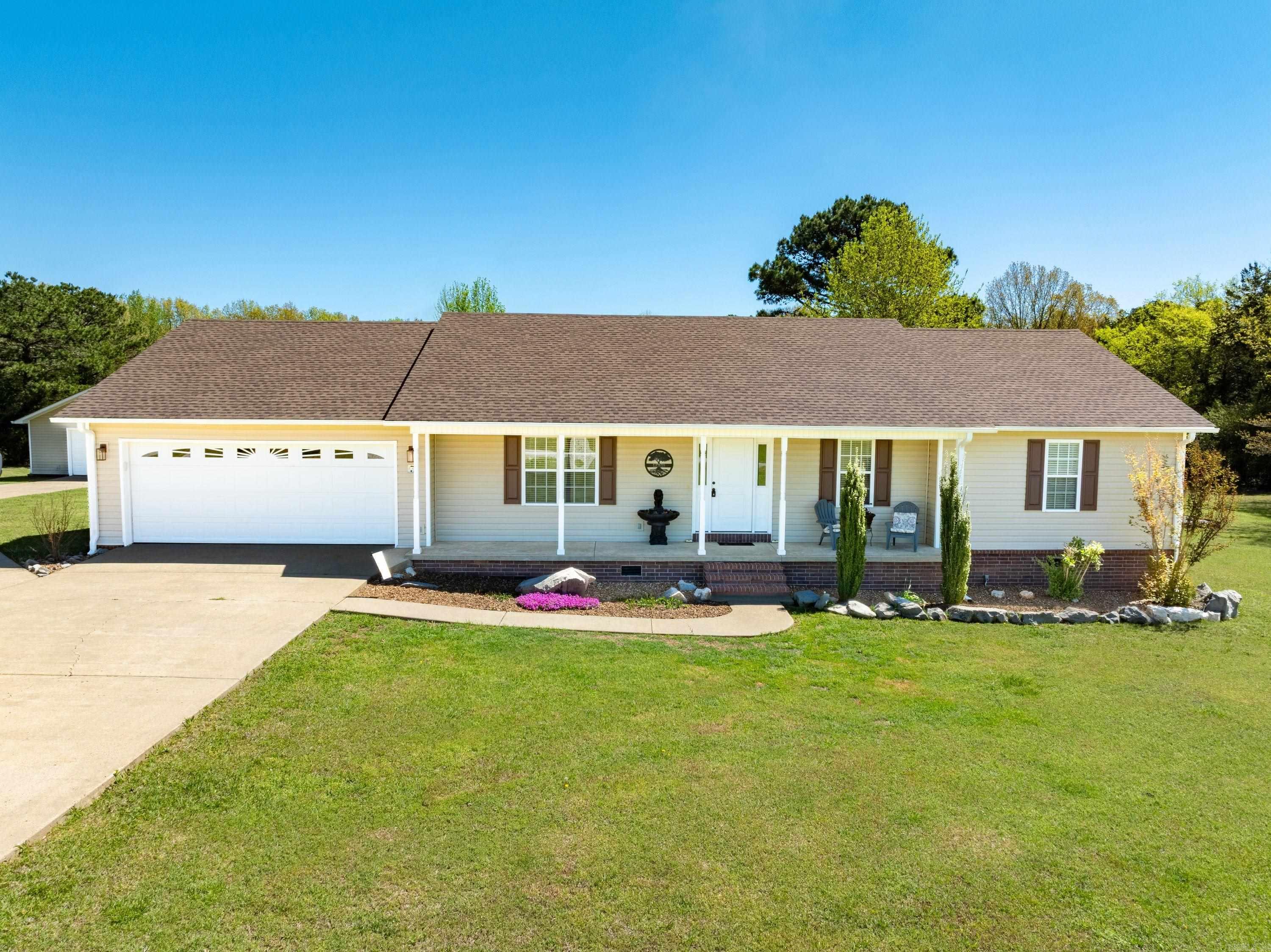 If you've been searching for the perfect combination of neighborhood living, privacy, and acreage, this beautifully updated 3-bedroom, 2-bath home on 4.65± acres is one you won't want to miss. Located in the sought-after Patterson Addition, it features new light flooring throughout for a fresh, move-in-ready feel. Enjoy lake views from the covered front porch, where geese and wildlife are a daily sight. Inside, the open living, kitchen, and dining areas flow to a partially covered back deck overlooking the above-ground pool and frequent deer crossings. The split floor plan offers a flex room, guest bedroom, full bath, and spacious primary suite with a walk-in closet. A detached shop, attached two-car garage, Curia Creek, wooded acreage, abundant wildlife, and community lake access complete this rare property, offering peaceful country living with neighborhood convenience in one of Cave City's most desirable locations. Relax with morning coffee on the deck, entertain family and friends, or unwind while watching nature from your own backyard. The concrete driveway, excellent curb appeal, and functional layout make everyday living easy while preserving the peaceful setting everyday.