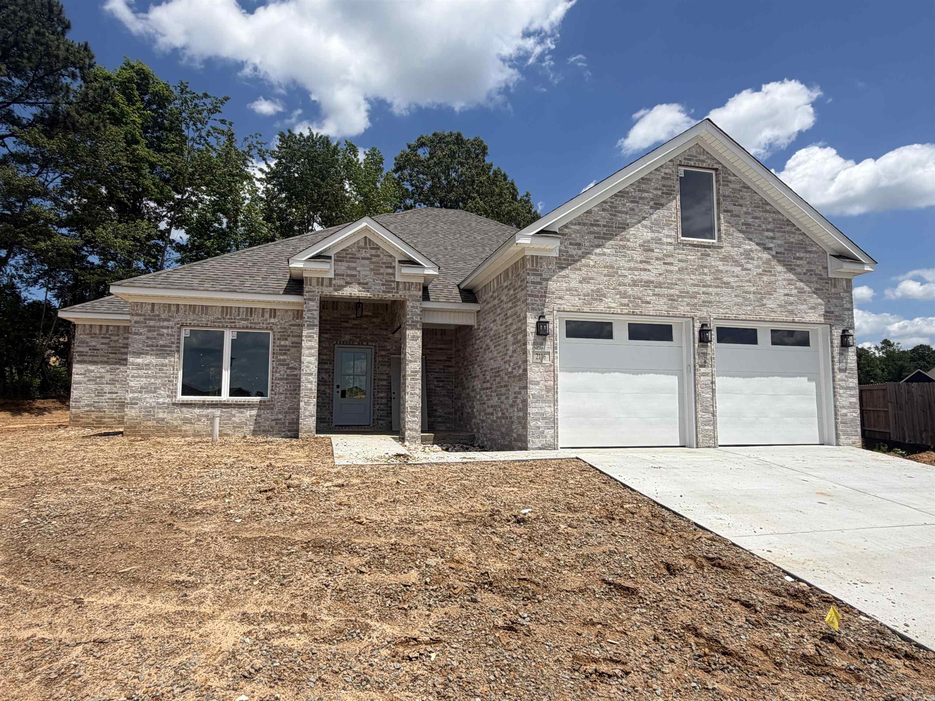 Welcome to this beautiful new construction home in the heart of Bryant! This all brick 4 bedroom, 3 bathroom home offers an open floor plan designed for both comfort and entertaining. The spacious living area features a cozy electric fireplace with floating shelves and cabinets on each side, creating the perfect focal point. The versatile 4th bedroom has a full bathroom and can easily serve as a bonus room, game room, guest suite, or home office. The primary suite is designed to impress with a stylish green accent wall and a spa like bathroom featuring a tile walk-in shower, soaking tub, and separate his-and-her vanities. The oversized primary closet connects directly to the bathroom and flows conveniently in the laundry room for added functionality. Don't miss your opportunity to own this thoughtfully designed home in a great location in Bryant!!