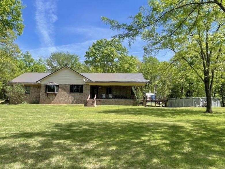 High-End Living with a Private Setting! This home was almost completely remodeled in 2019.  3 bedrooms, 2.5 baths, two living areas, large utility room, water softener, water filteration system, 2-car attached garage, rural water plus well, 20X30 shop with a conrete floor and electricity, greenhouse, pool, nice front porch with a beautiful view, attic fan, and a new roof and gutters in 2023! This home has a very spacious open floor plan.  Quartz countertops and tons of cabinet space in the kitchen, a gas log fireplace in the main living area, a screened-in porch that is already wired for a hot tub, a half bath and big closet in the second living area, luxury vinyl flooring throughout (except two of the bedrooms), and so much more! This home and property is well-maintained, the setting is mostly open with scattered trees and some woods, and you don't have to worry about anybody seeing go for a swim in your pool because you can't see any neighbors! The only thing this property needs is you!