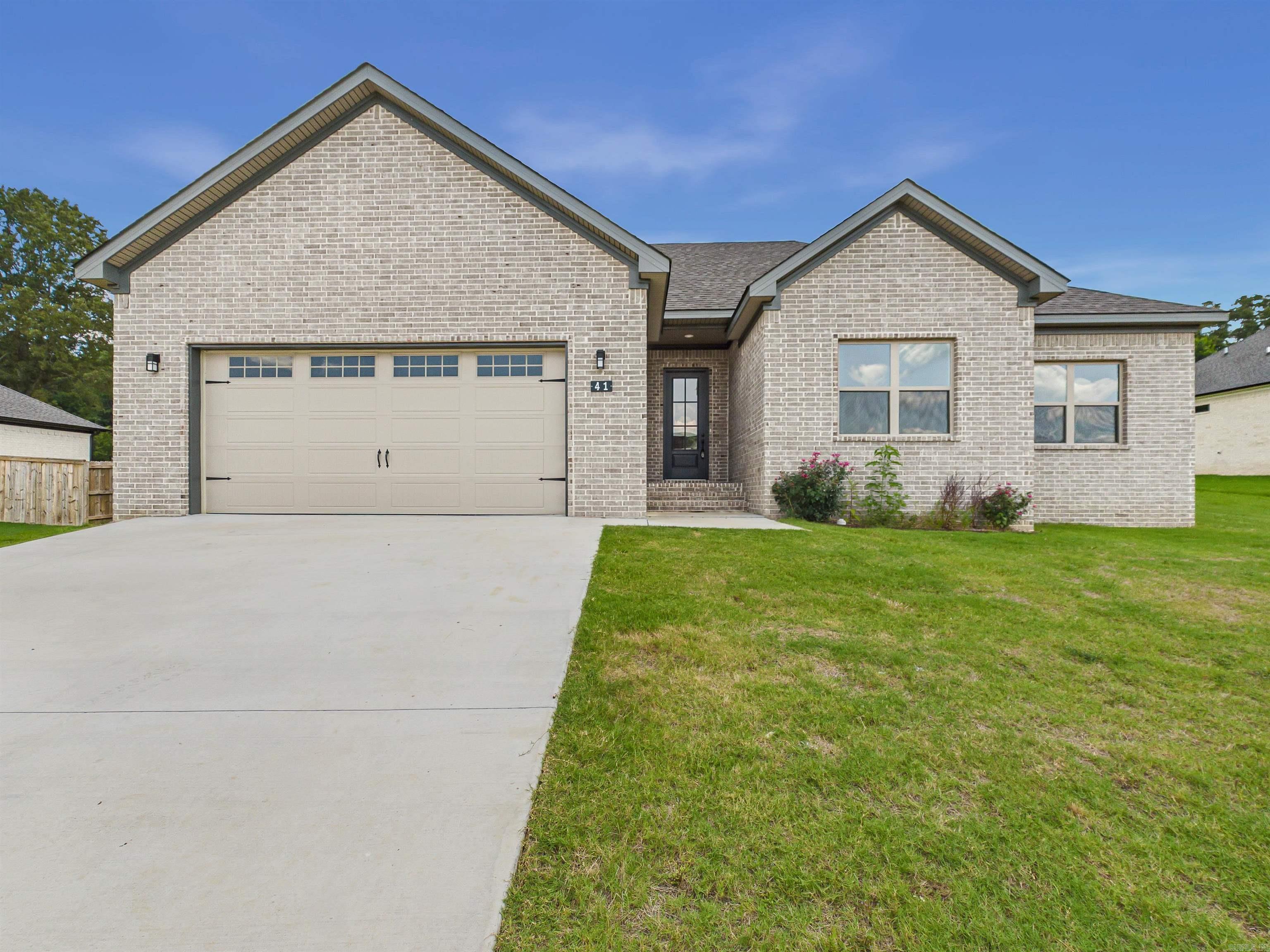 This NEW CONSTRUCTION and ALL BRICK beautifully appointed 3 bed, 2 bath home blends style and comfort with an open layout. Tall ceilings, beautiful trim work lvp throughout and a STUNNING statement fireplace wall. The kitchen shines with quartz countertops, pantry, ss appliances and modern appeal, The primary bath includes a gorgeous tile shower, vessel tub and so much more. Enjoy mornings on the back porch and evenings in the large backyard—perfect for making memories. This location is so convenient for family and friend activities with the Weaver Family Park area and Vilonia Softball Complex within walking distance! This is a must see. ** See remarks**