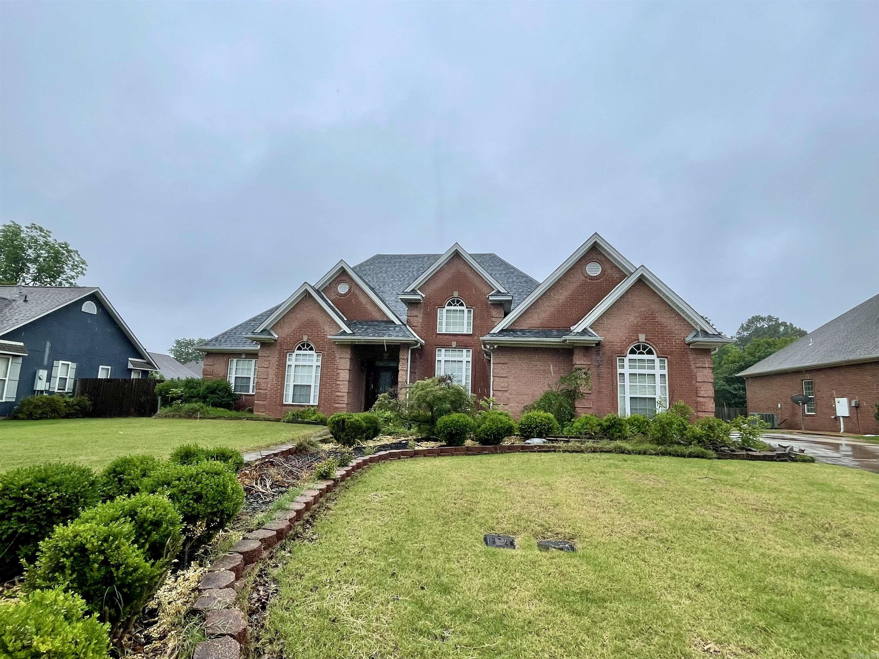 1013 Brownstone Dr. in Jonesboro, Arkansas is a 3 bedroom, 2.5 bath home on a beautiful landscaped lot. The primary suite is large with a walk-in shower, separate tub, two closets, and a safe room. There is also an office, separate formal dining room, hardwood flooring with mahogany inlay, 10-11ft ceilings, abundant storage, and a sprinkler system. A new roof was installed in 2024 and there are 2 HVAC systems, one outside unit was replaced in approx. 2020 and the other in 2025. You'll love all that this home has to offer! Call your favorite REALTOR® and schedule your private tour.
