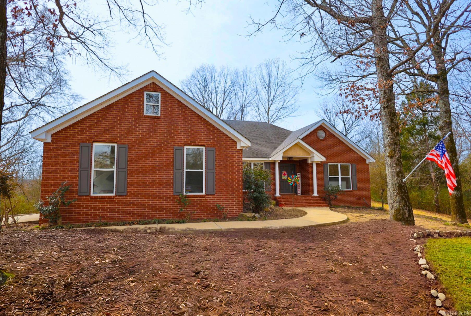 Brick home perched on a hill in Glenwood offering privacy while still being just minutes from town conveniences. This stately 3 bedroom,2 bath home features approximately 1,995 sq ft of comfortable living space in the Centerpoint School District. Inside, you’ll find an open-concept living and kitchen area designed for both everyday living and entertaining. In addition to the three spacious bedrooms, there is a versatile bonus room that could easily serve as a formal dining room, home office, or even a 4th bedroom. Enjoy outdoor living from the large back deck overlooking the backyard, offering great space for gatherings or relaxing evenings. The property also includes a garage and a storage building, providing ample room for tools, hobbies, or extra storage. Conveniently located near the Caddo River and the Glenwood Country Club golf course, this home combines convenience with a setting that feels set apart.