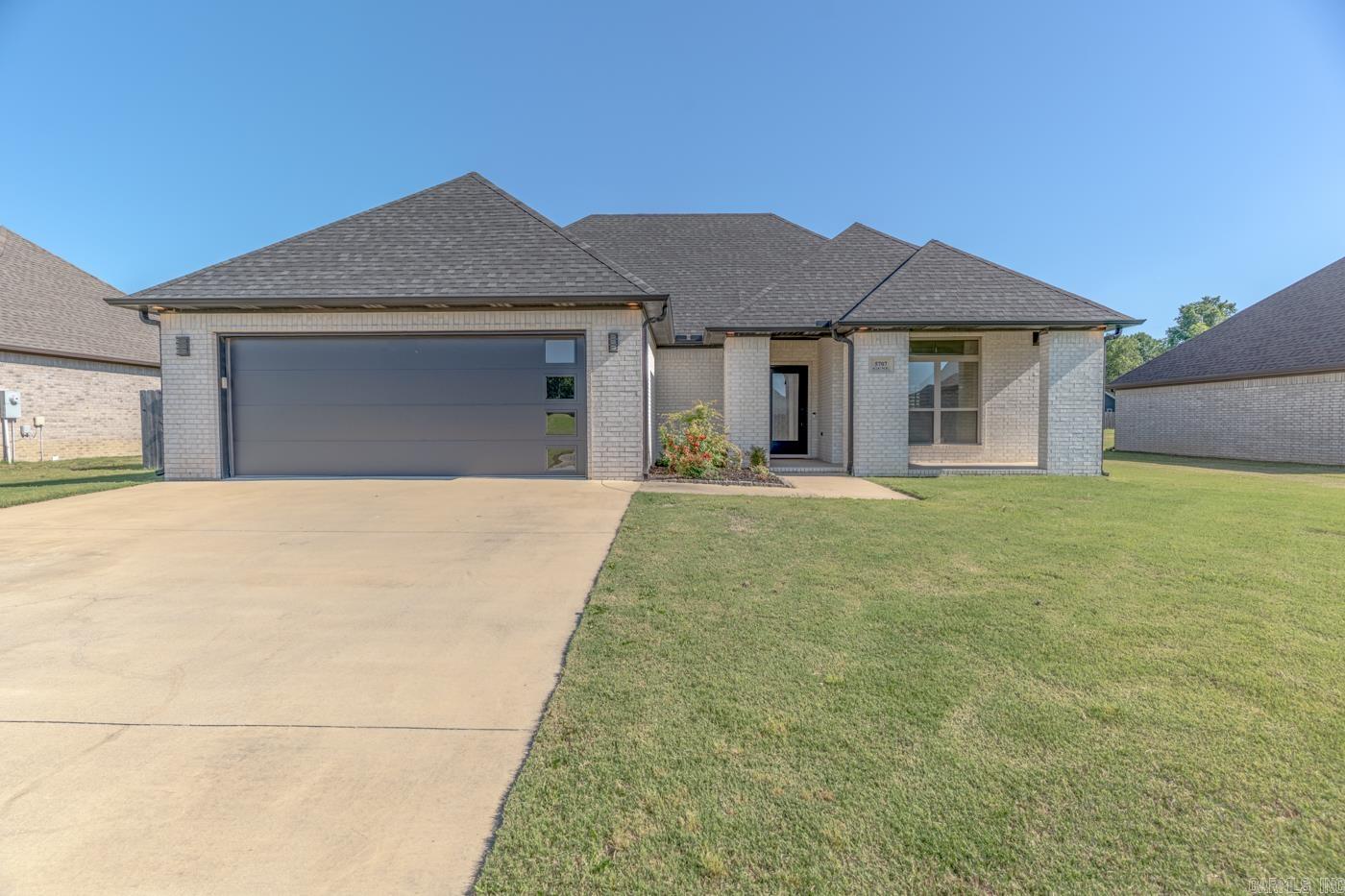 Welcome to Market, 5707 Gene Street of the Walcott Springs Subdivision in Paragould, AR. Modern elegance meets everyday comfort in this stunning newer construction home situated on .19 +/- acreage. This home features crisp white brick, guttering, well maintained landscape, french drainage and eye-catching architectural details. Inside, you'll find approximately 1,512 +/- square footage featuring 3 bedrooms, 2 bathrooms, and an inviting open-concept floor plan. This spacious living area flows seamlessly into the kitchen, where stainless steel appliances, generous cabinetry, and an eat-in bar with seating create the perfect space for gathering and entertaining. The primary suite is thoughtfully designed with a tray ceiling, a luxurious walk-in shower, and separate walk-in closets. Outdoor living is equally inviting with covered front and back patios and a fully wood privacy-fenced backyard. A perfect combination of style, comfort, and functionality, this home is ready to welcome its next owners.