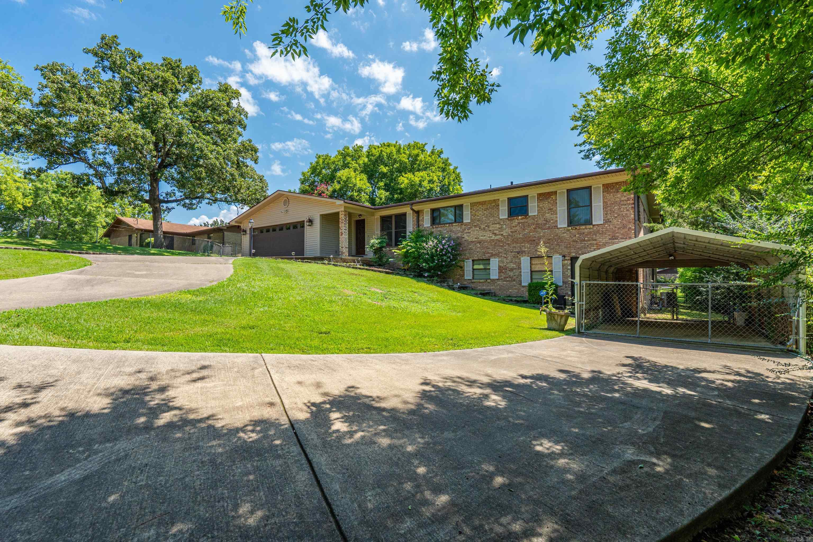 Welcome to this exceptional 3-bedroom, 3½-bath home offering approximately 3,900 square feet of comfortable living space on a generous 104' x 317' lot. Ideally located just minutes from shopping, groceries, hospitals, doctors' offices, pharmacies, and Oaklawn Racing Casino Resort, this home combines convenience with privacy.  Inside, you'll find several spacious living areas, a formal dining room, a dedicated laundry room, and a large enclosed back porch that's perfect for year-round enjoyment. The highlight of the home is the private indoor swimming pool, providing relaxation and entertainment in every season.  Outside, the property features a large two-car garage, an additional covered parking area, and a circular driveway that offers ample parking for family and guests. With its generous room sizes, outstanding amenities, and prime location, this is a rare opportunity to own a truly distinctive home.